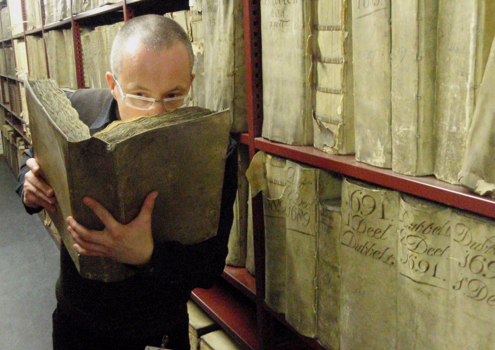 Prof. Matija Strlic smelling a historic book in the National Archives of The Netherlands ©Matija Strlic