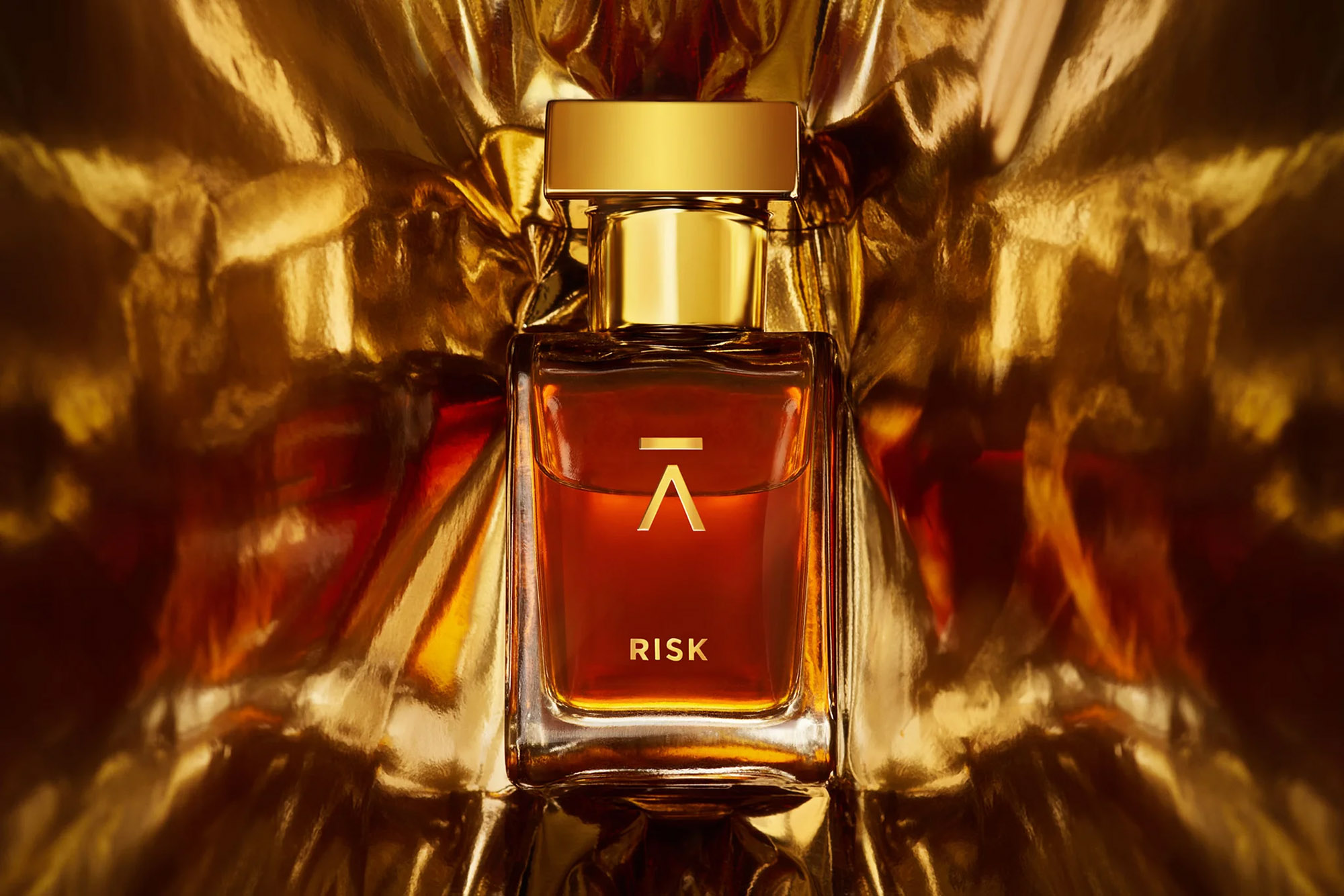 Risk bottle against a background of gold foil.