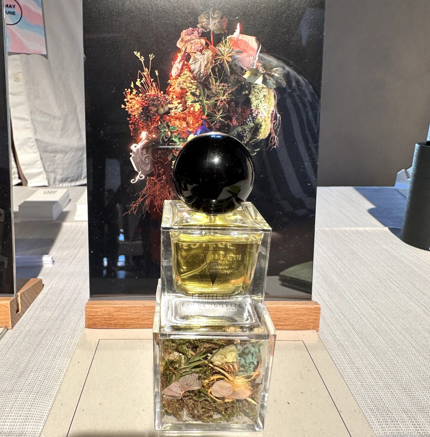 A bottle of Miskeo fragrance on its stand