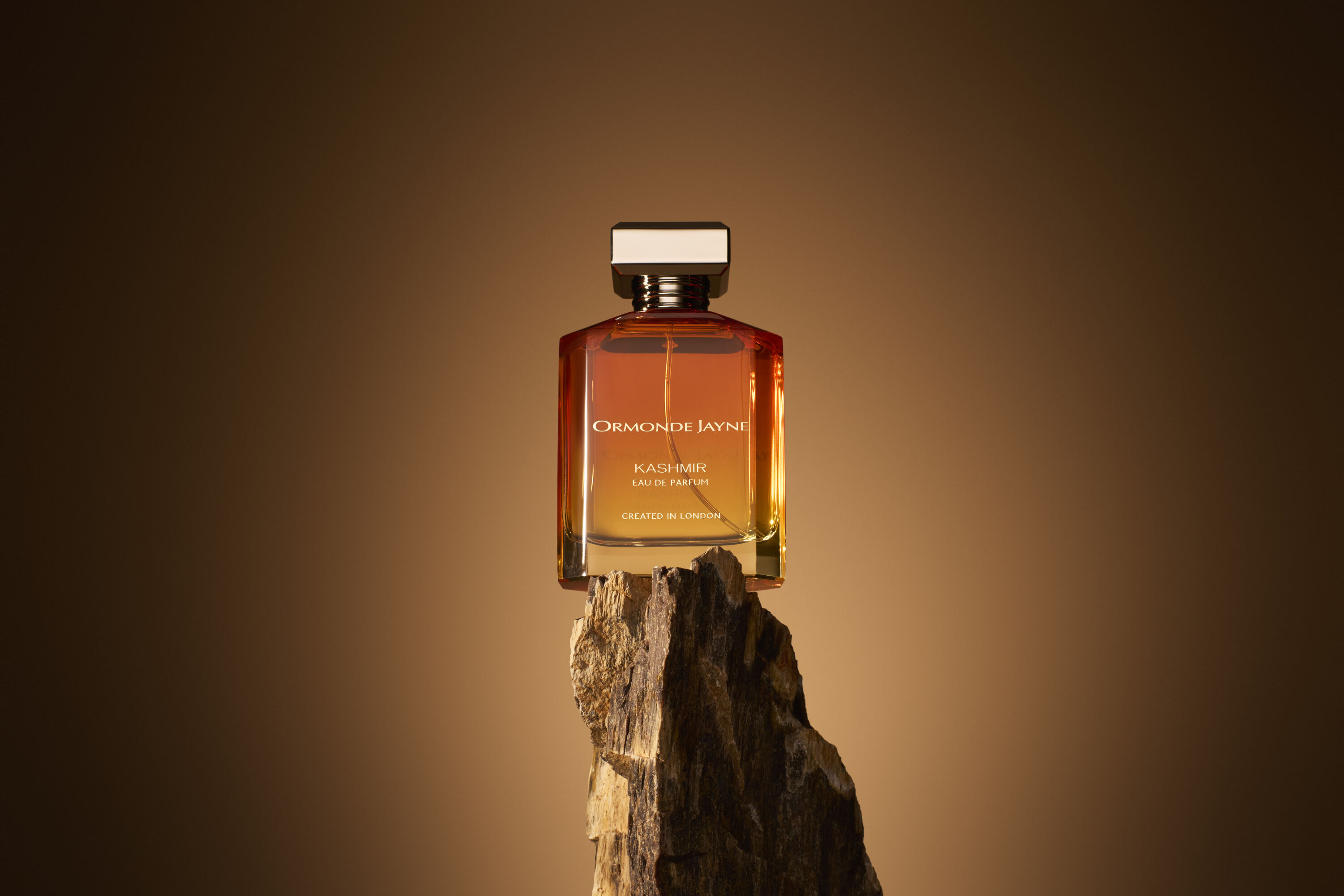 Ormonde Jayne Kashmir bottle on piece of tree trunk
