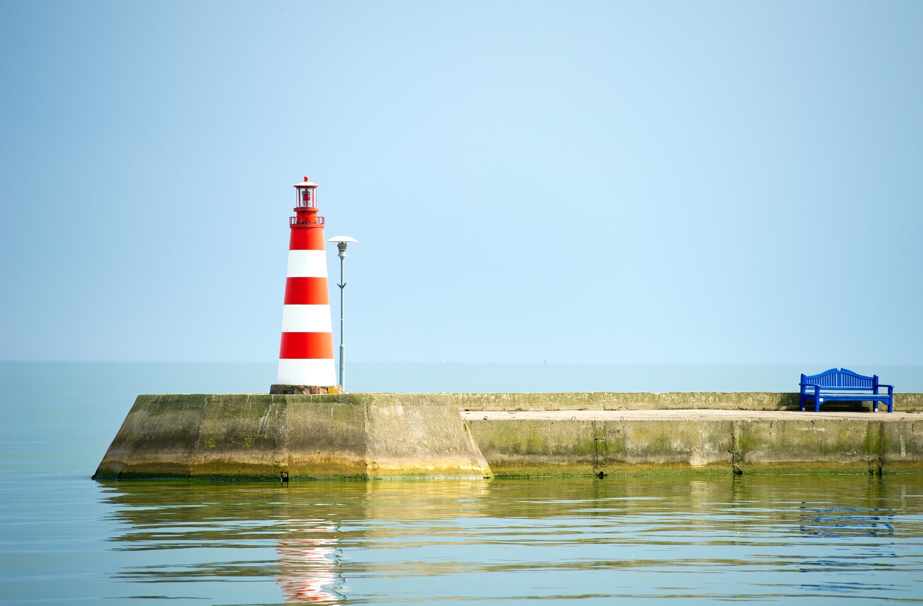 Image of lighthouse in front of sea and sky