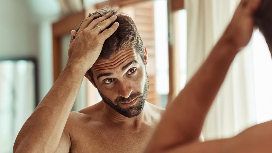 man fixing his hair