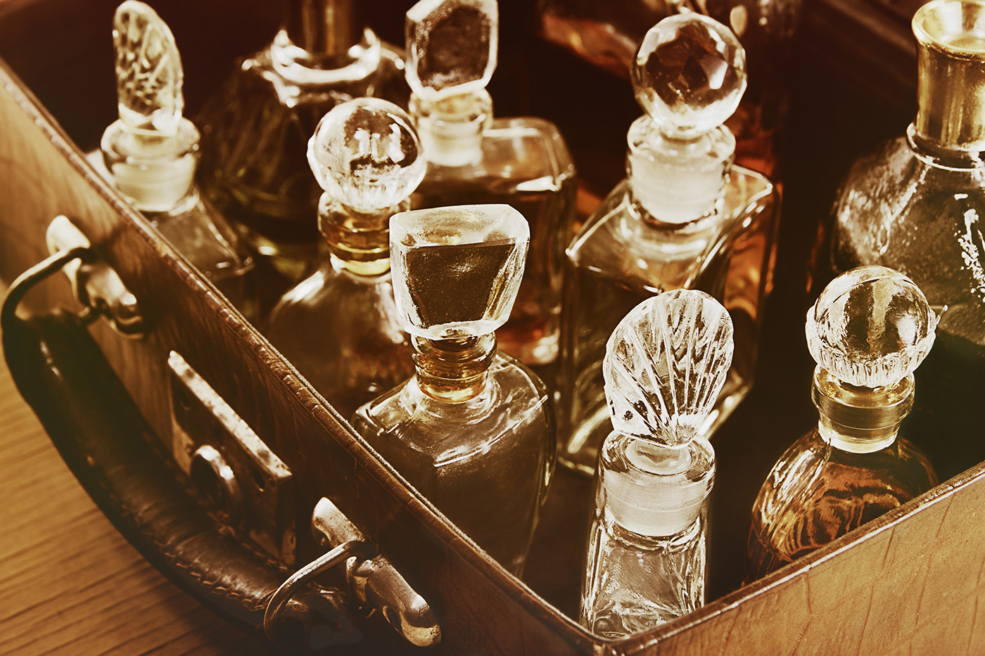 sepia photo of antique crystal perfume bottles