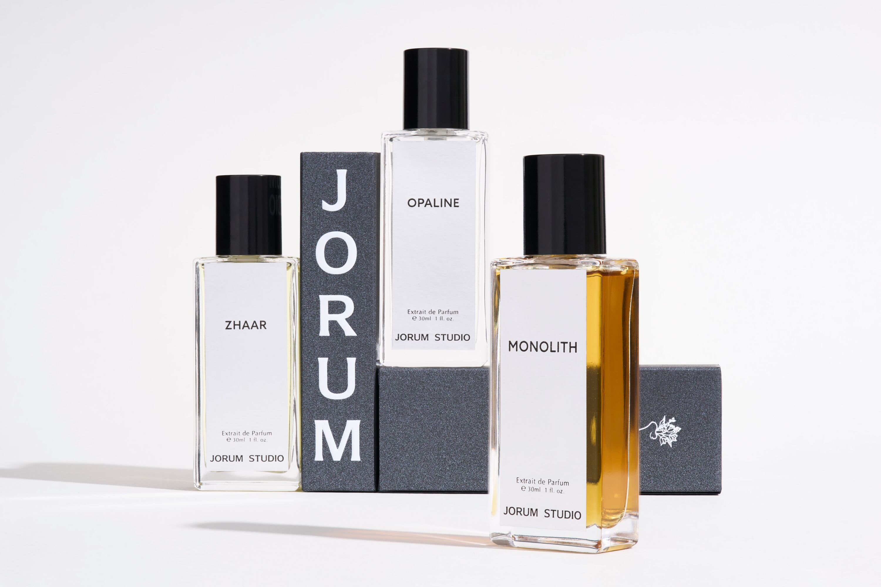 A group of Jorum Studio fragrances set against a white background and stood on boxes from the brand