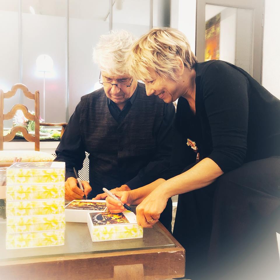 Michel and Clara signing perfume boxes