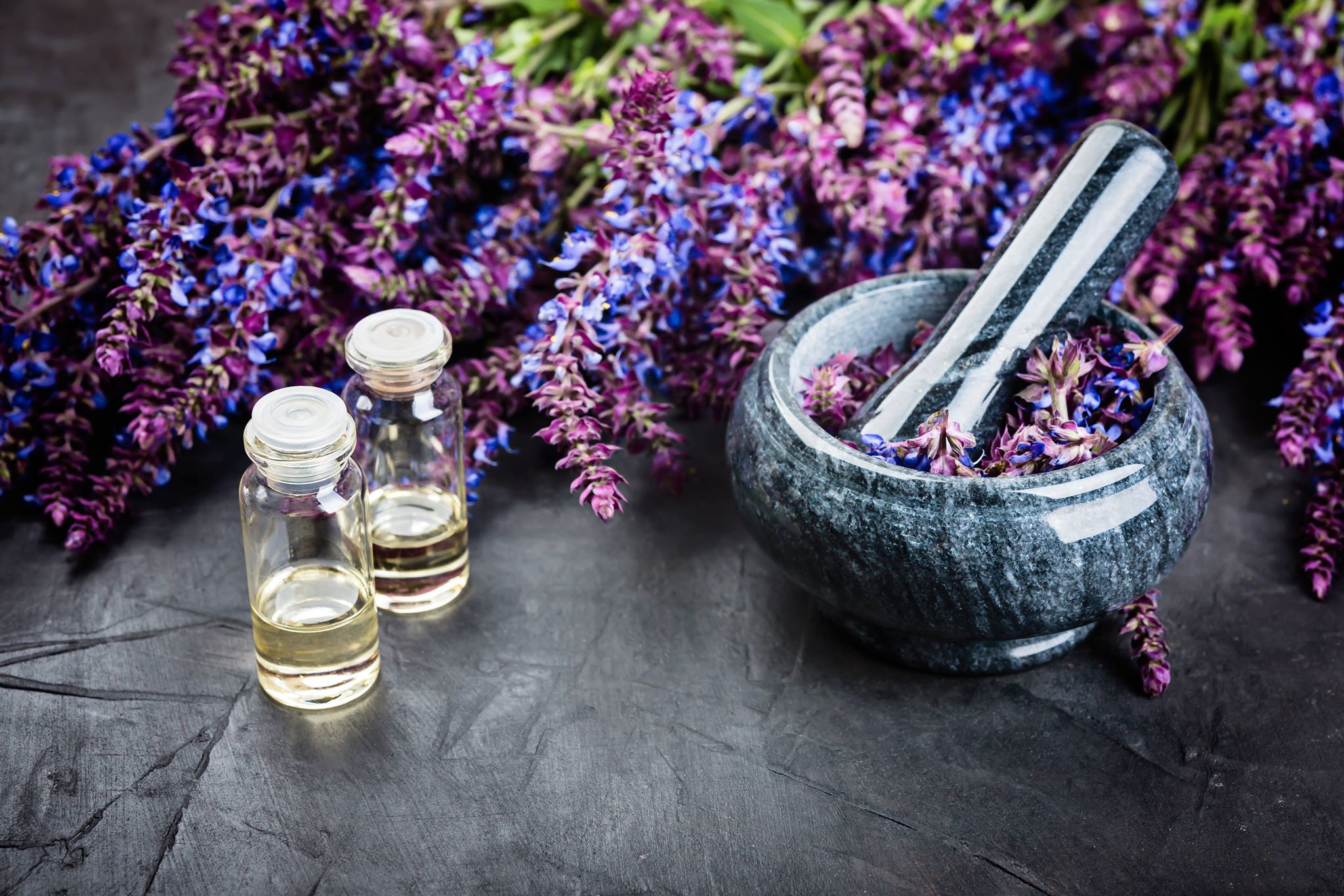 vials of lavender oil with lavender flowers