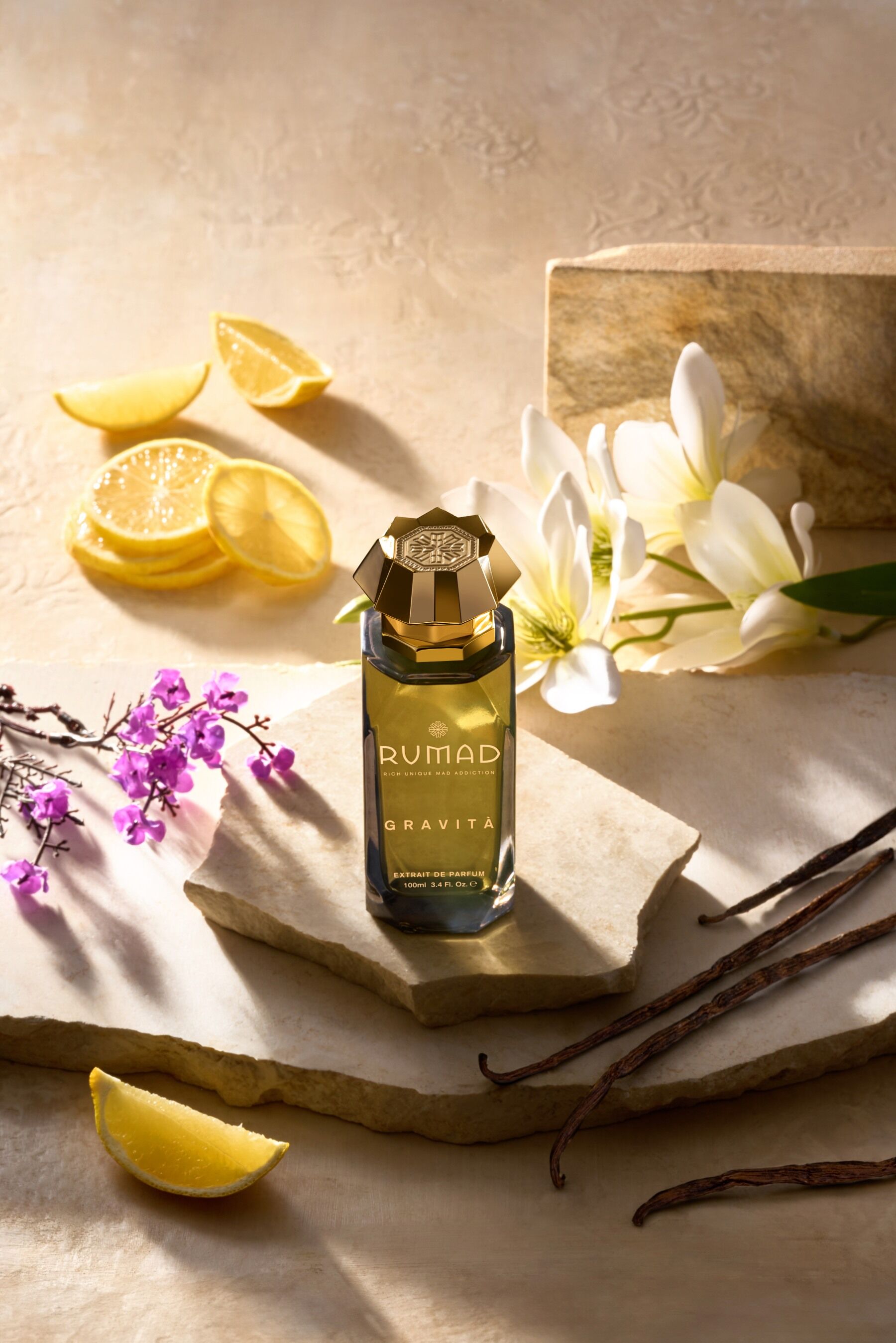 Gravita by Rumad set against a backdrop of flowers and fruits