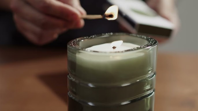 diptyque candles getting lighted with match 