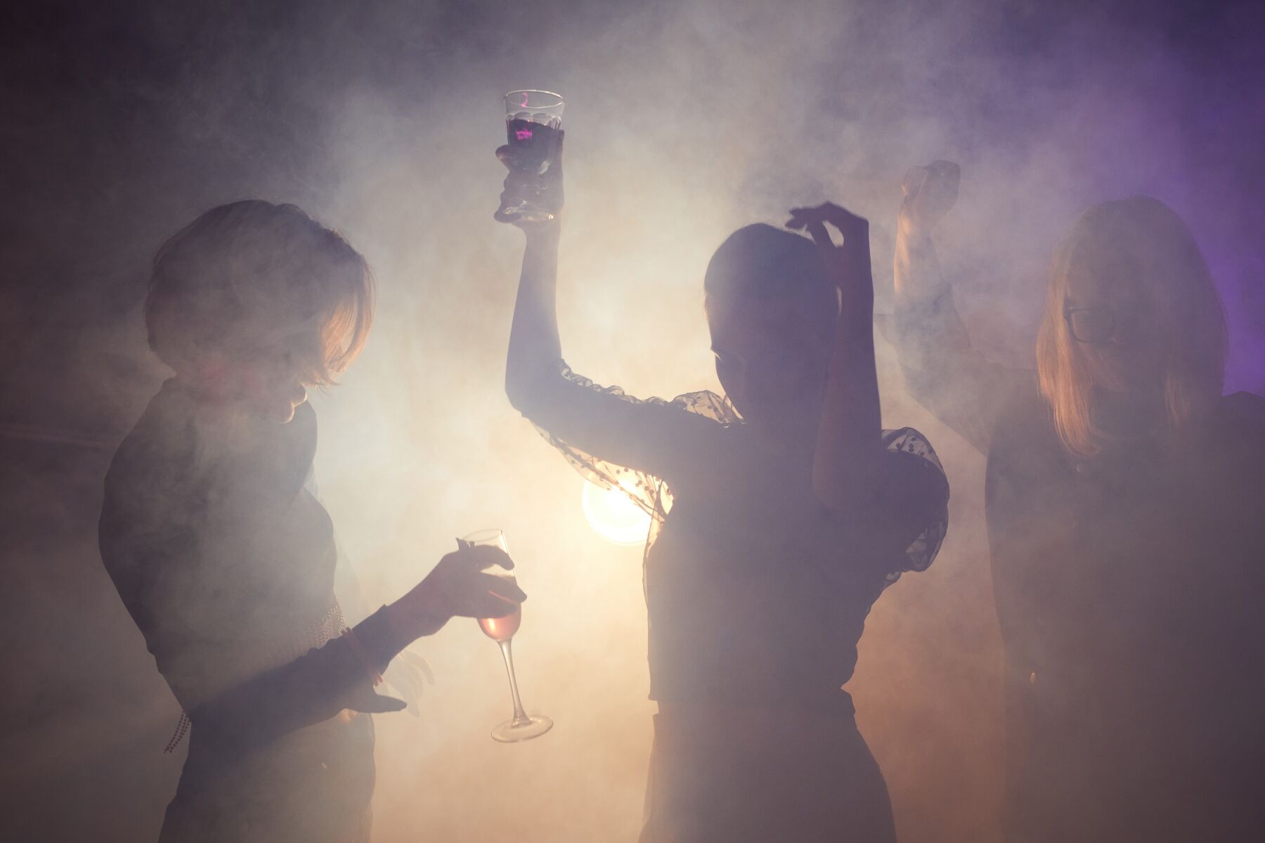 A smoky club with people dancing in the fug