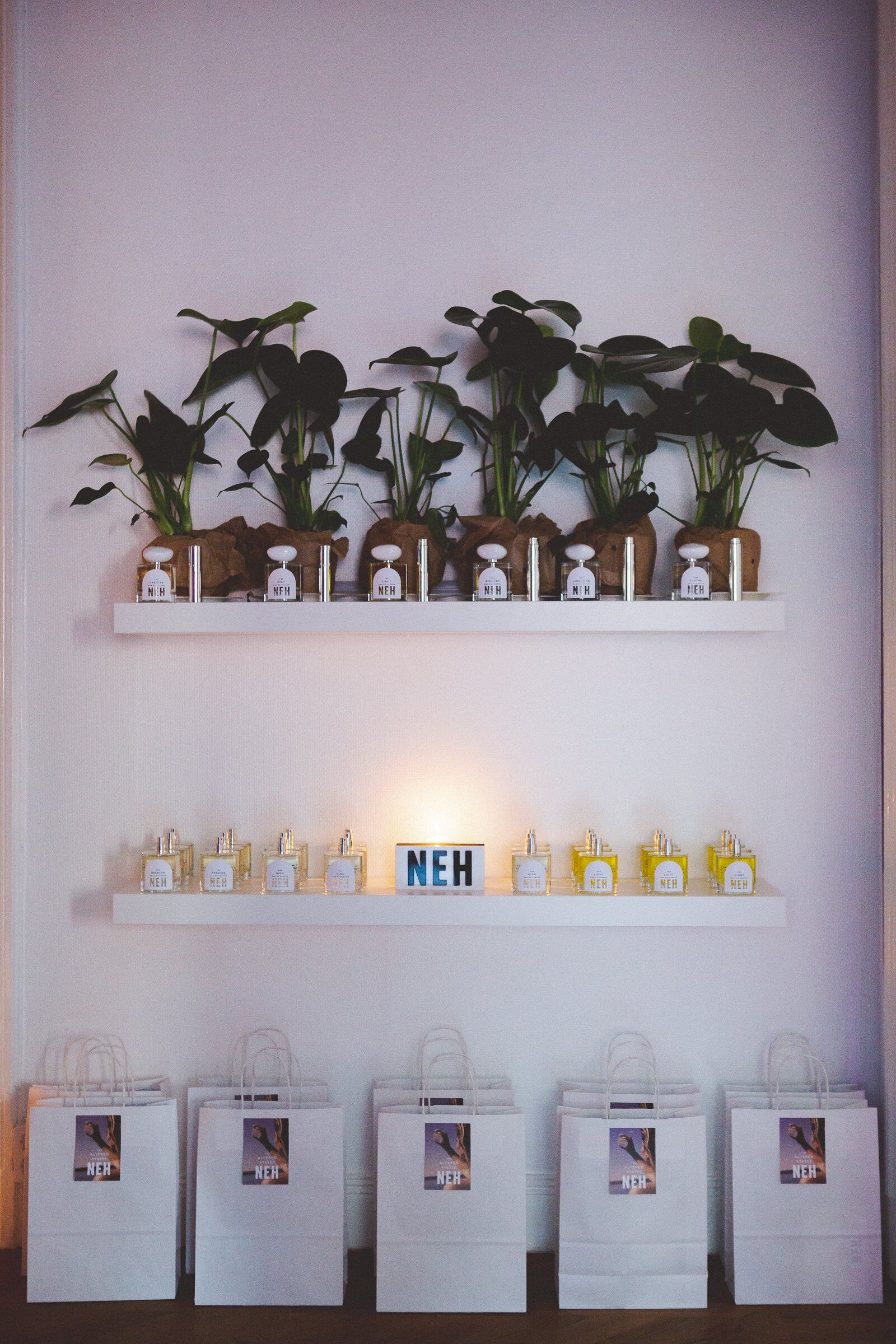 A shelf stacked with Neh perfumes