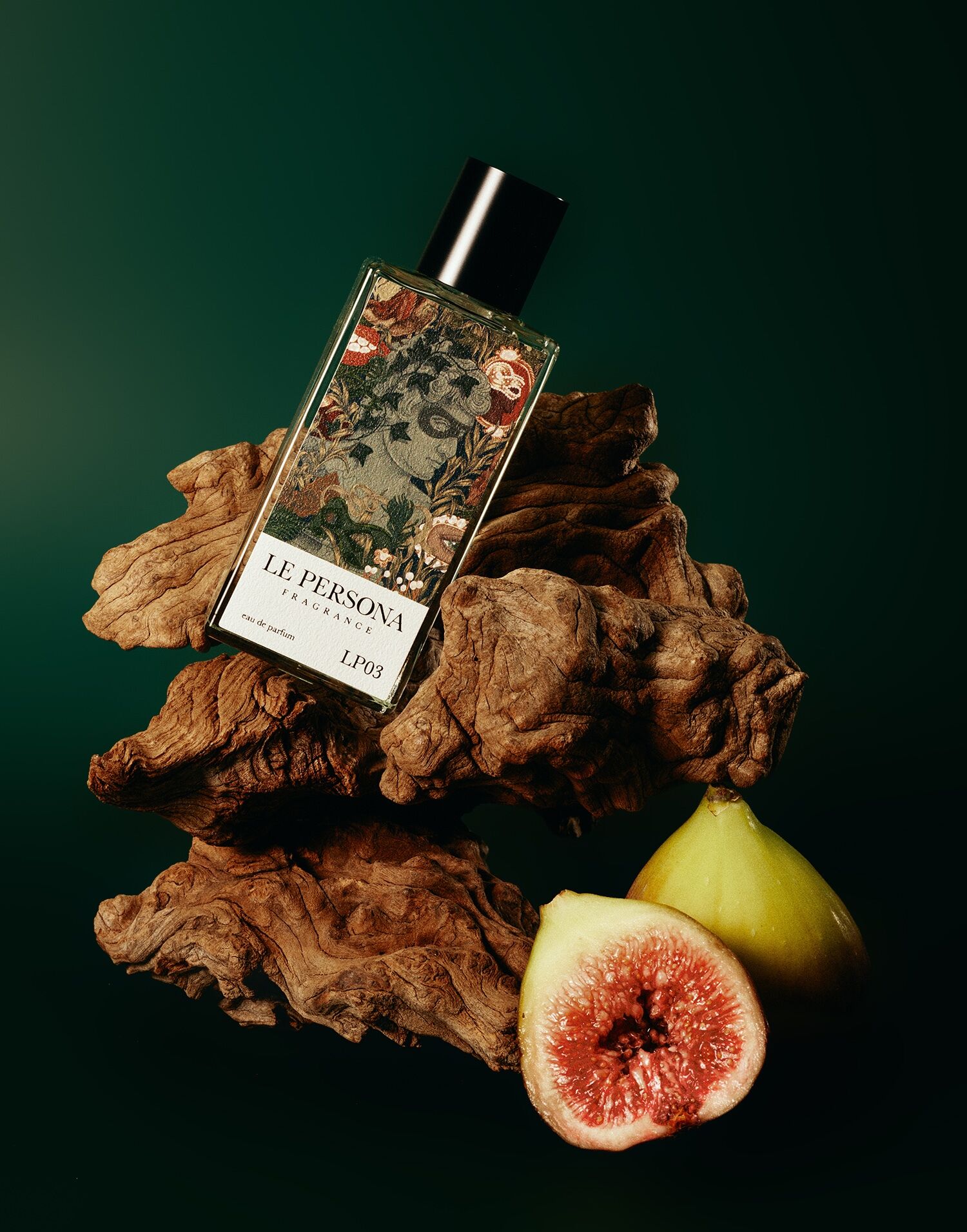 La Persona's Wooden Face shown on a green backdrop with a chunk of wood and figs