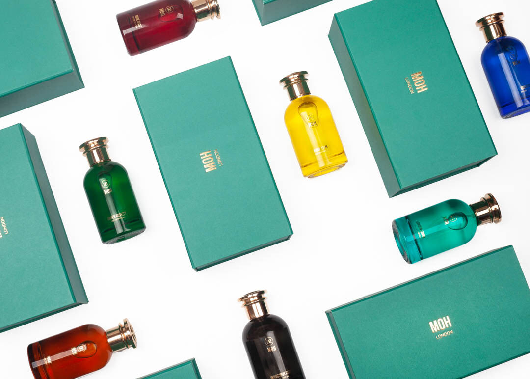 MOH perfumes laid flat on a white background with green boxes around them
