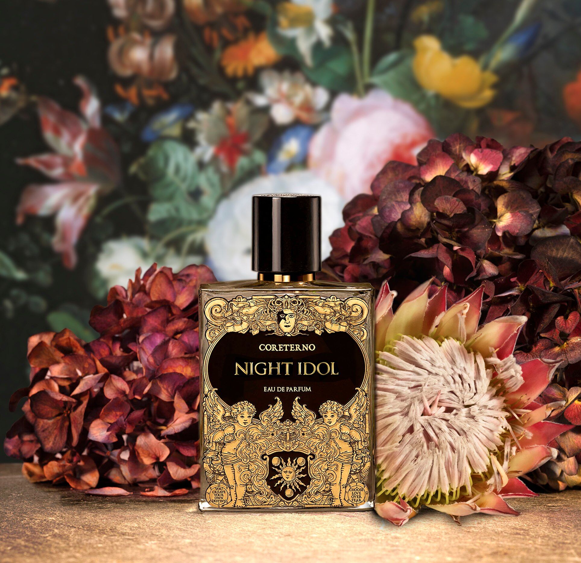 Night Idol perfume set against a busy backdrop of flowers of all different colours