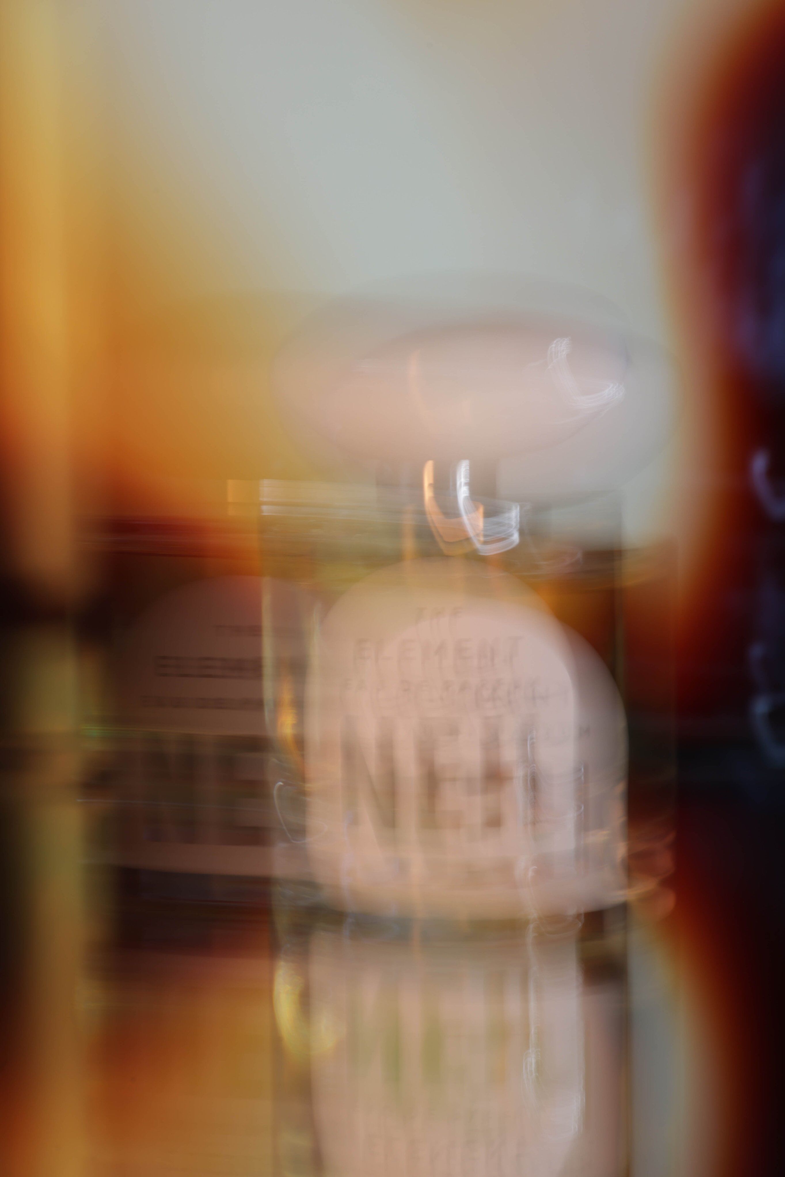 A bottle of the Neh perfume made abstract by blurring