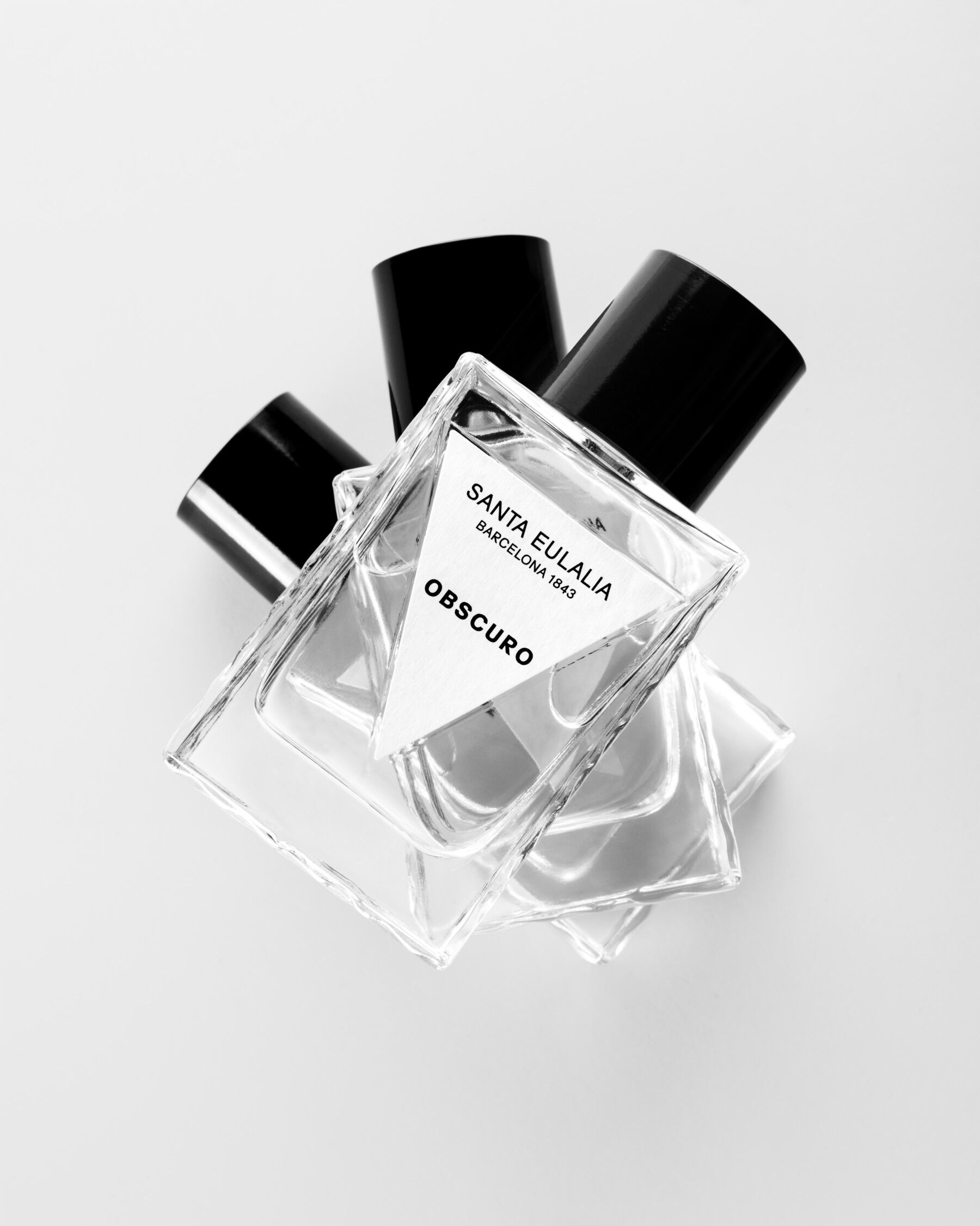 A stack of bottles of Obscuro shot in black and white