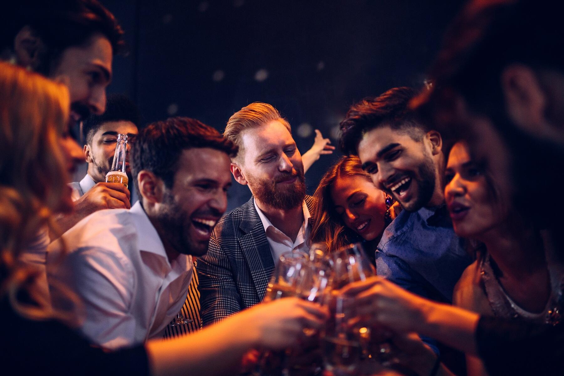 Men in a club with drinks in their hands