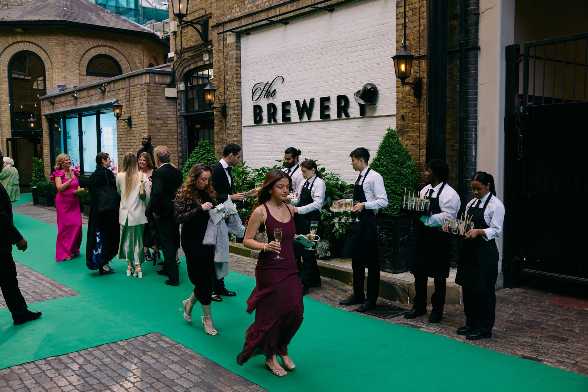 Guests arriving for the awards ceremony wearing black tie