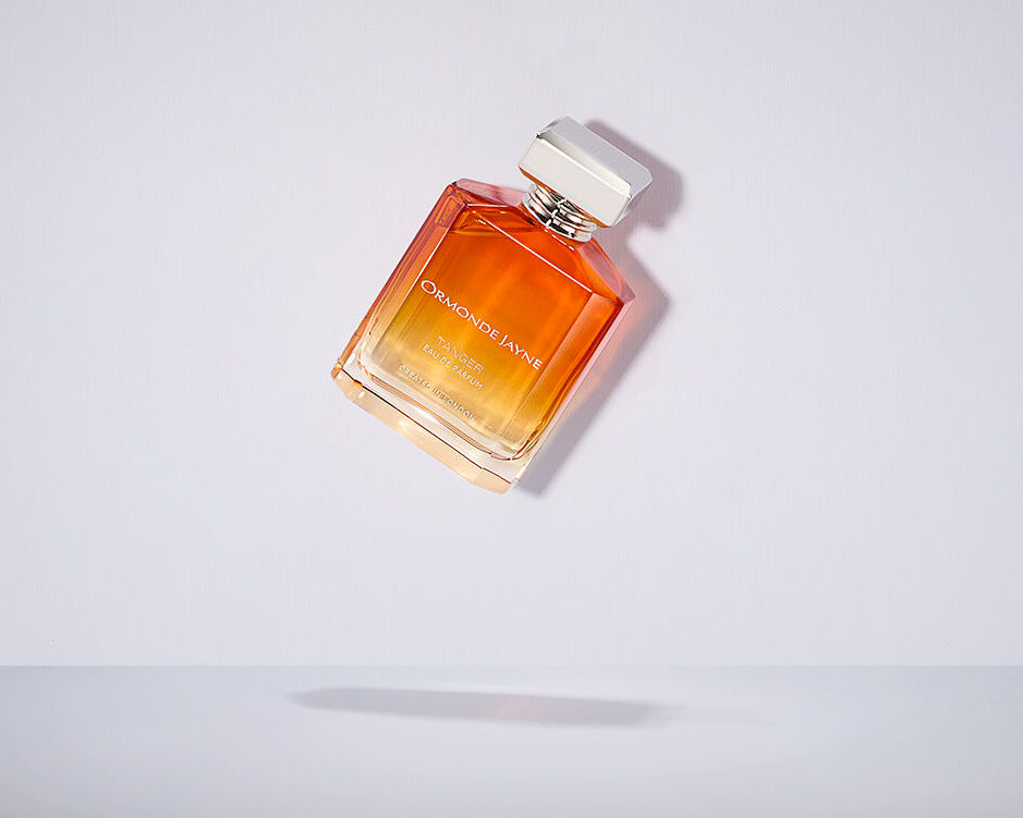 A bottle of Tanger by Ormonde Jayne being dropped on to a white surface and against a white backdrop