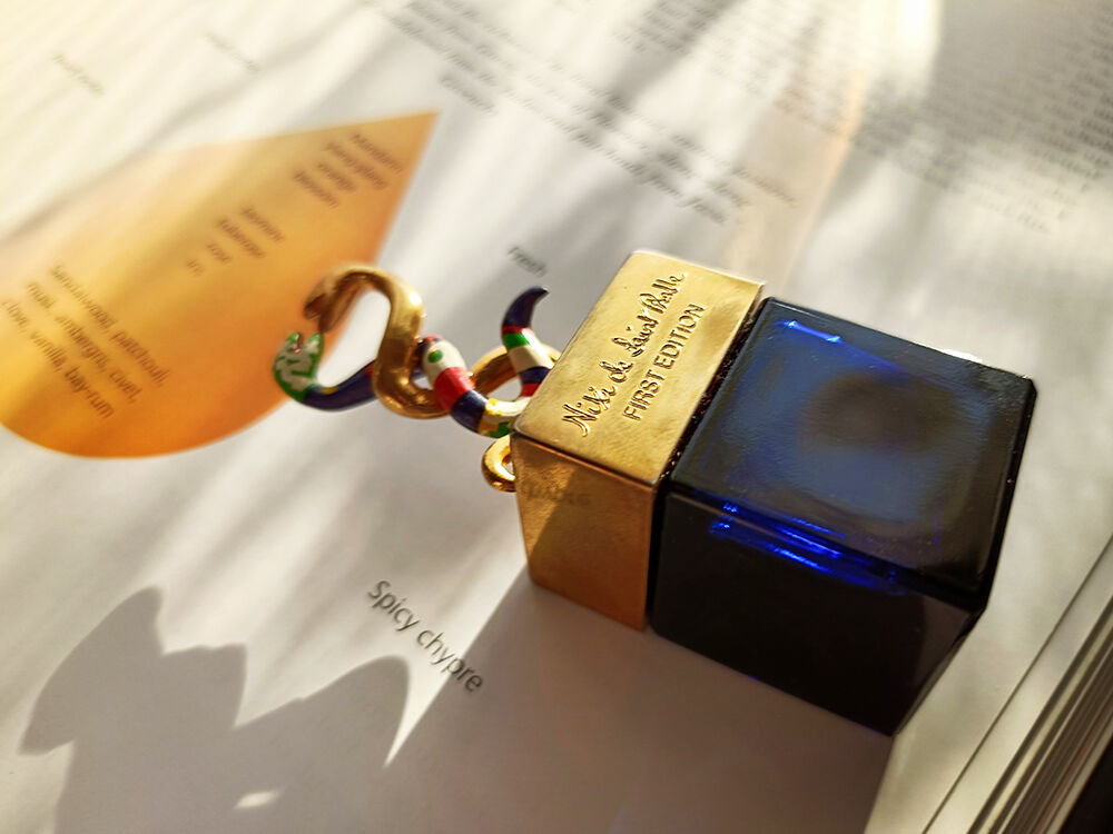 Nikki de Saint Phalle bottle on book background.