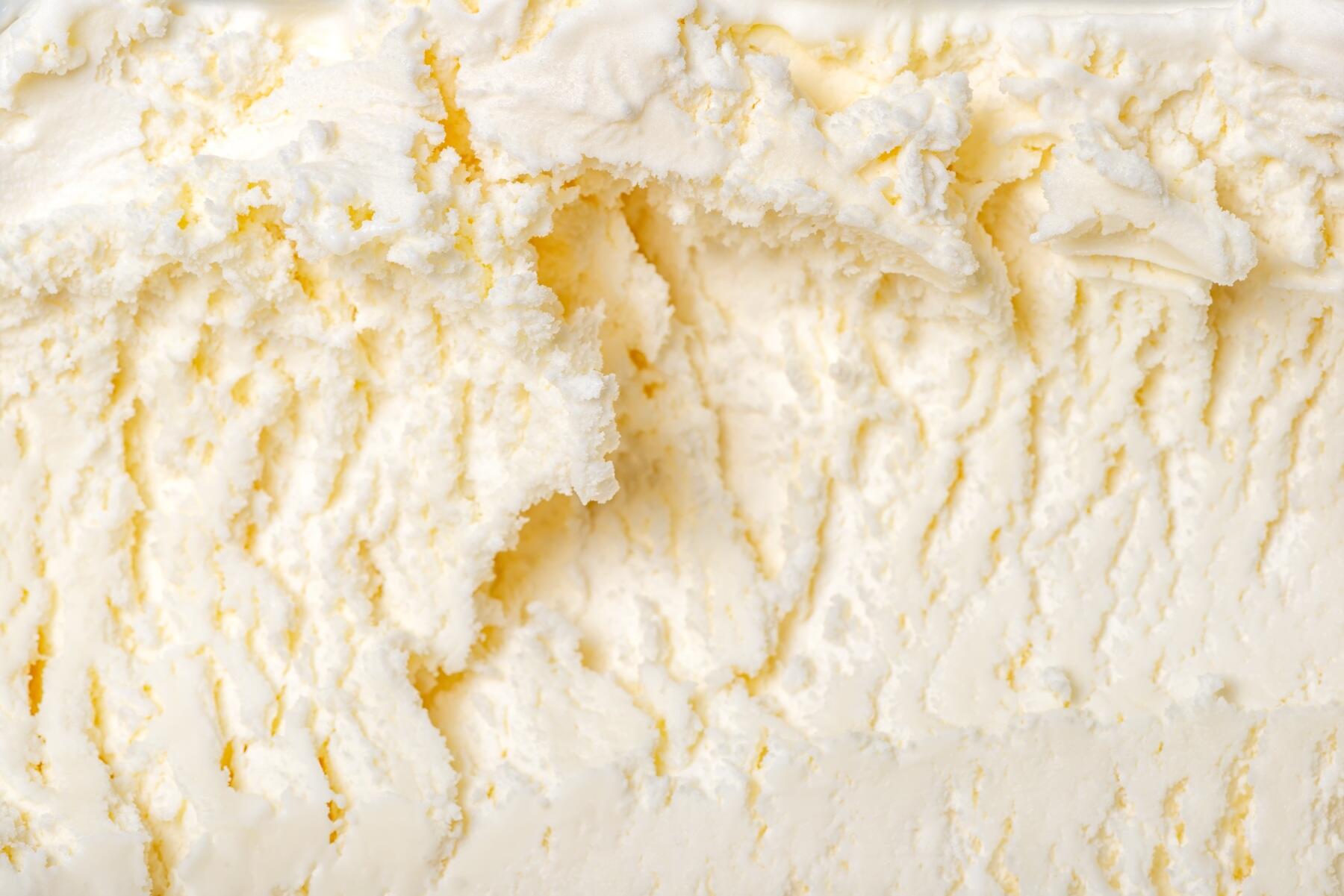 A close up of ice cream showing an off white colour and granular texture