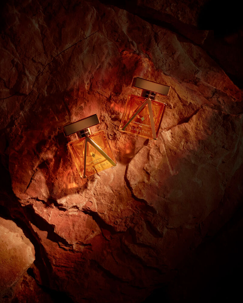 Two perfumes on a shadowy stone backdrop