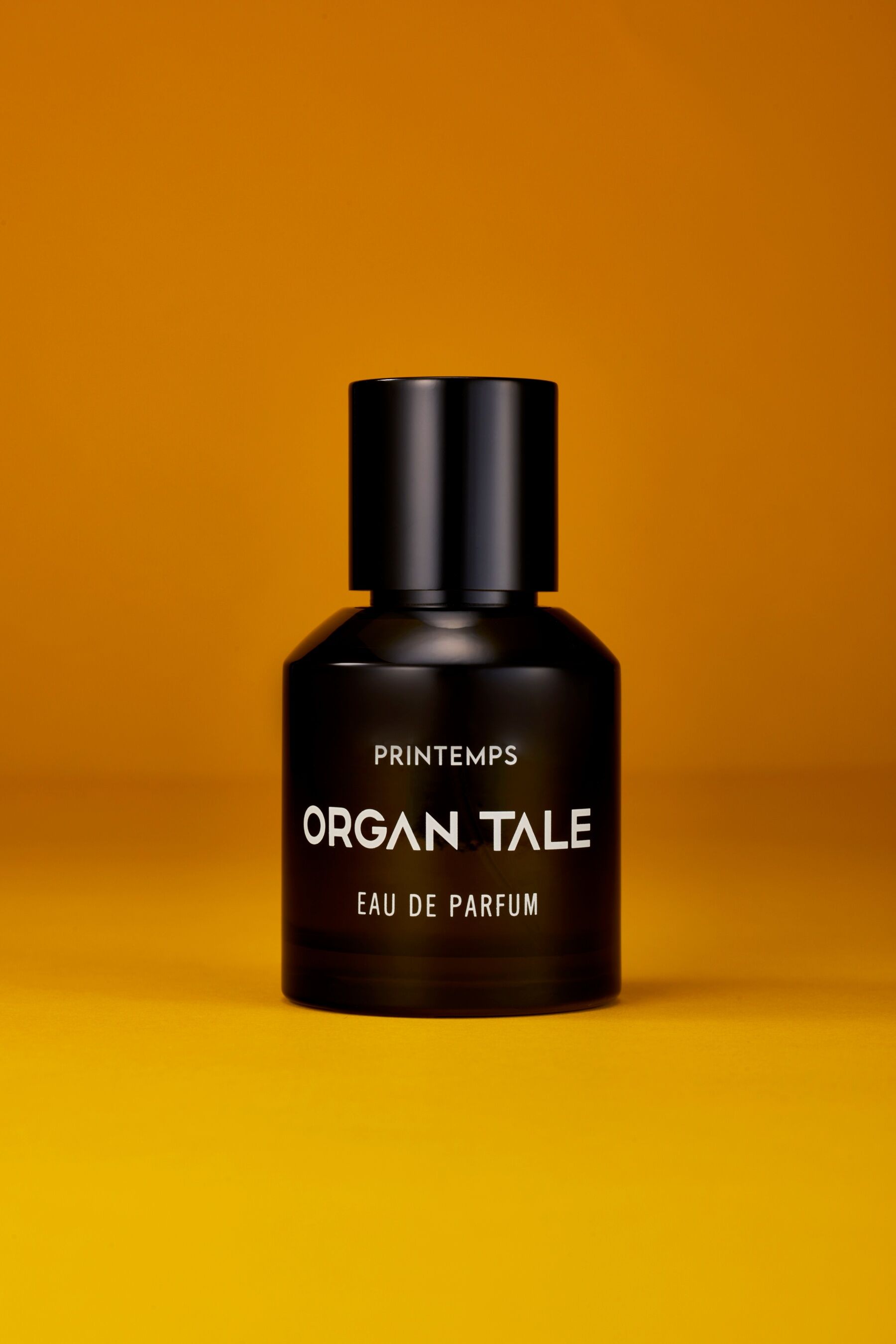 A bottle of Printemps by Organ Tale stood against a warm yellowish background