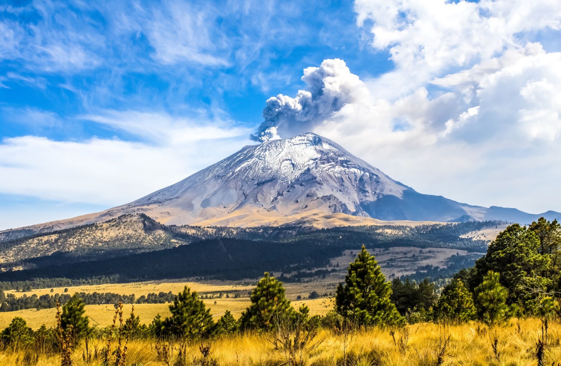 A smoking volcano in a beautiful landscape