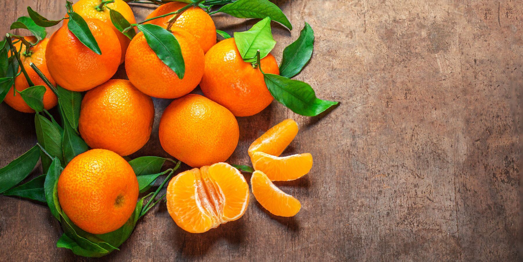 Mandarin oranges against a wooden backdrop