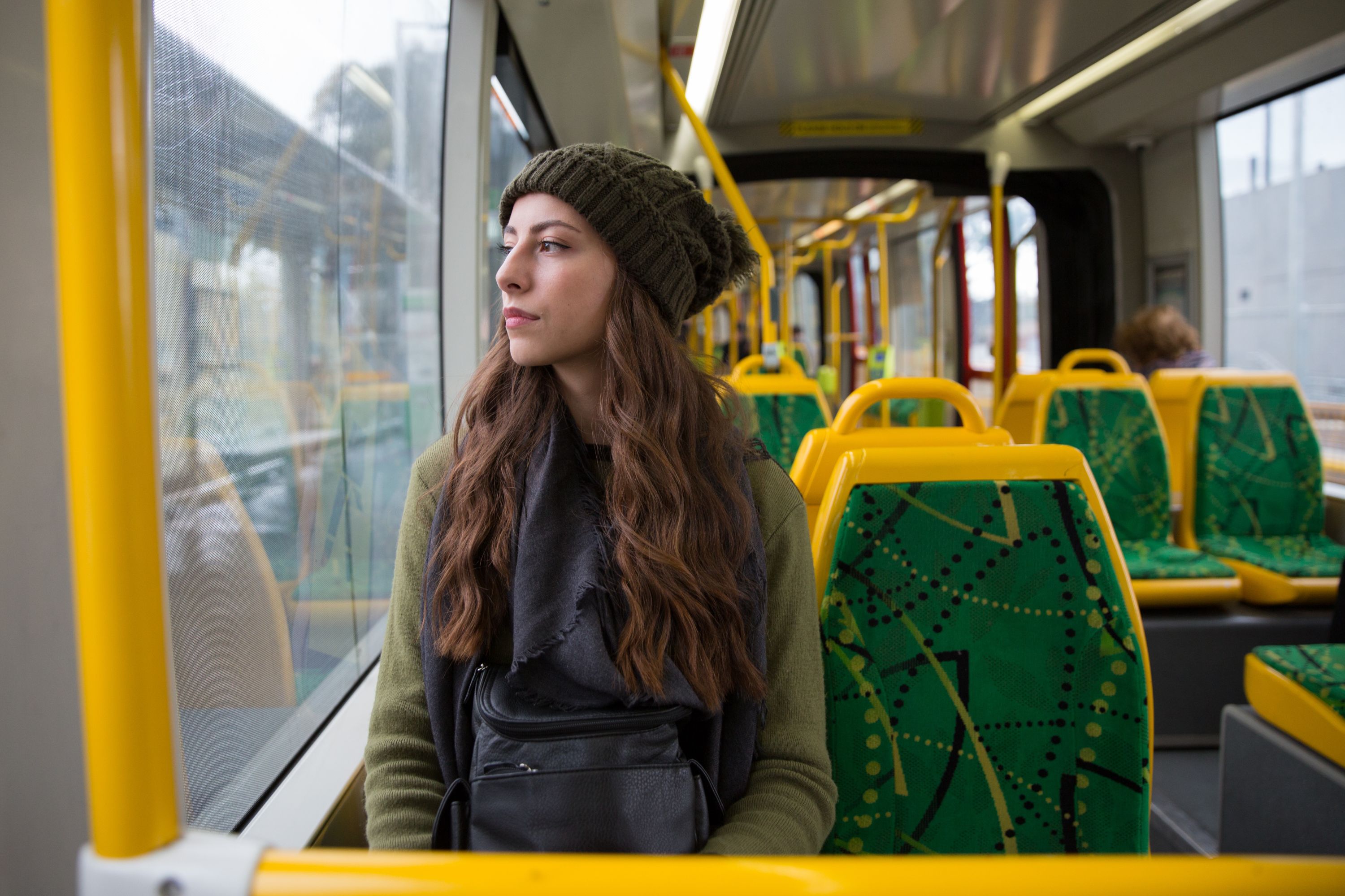 Young Woman sitting in an Melbourne tram， Flaner Sonic Silver perfume is inspired by Melbourne tram tracks