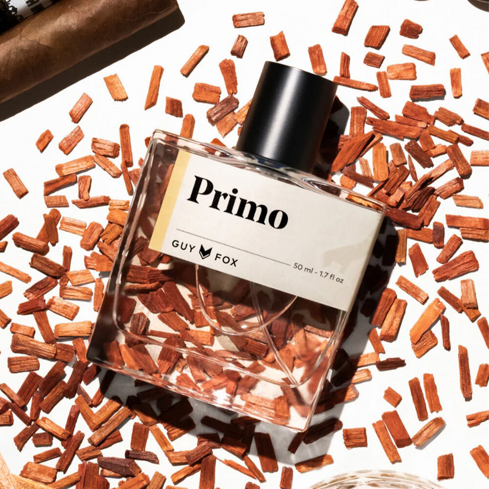 Primo Extrait de Parfum on a background of cigar tobacco.