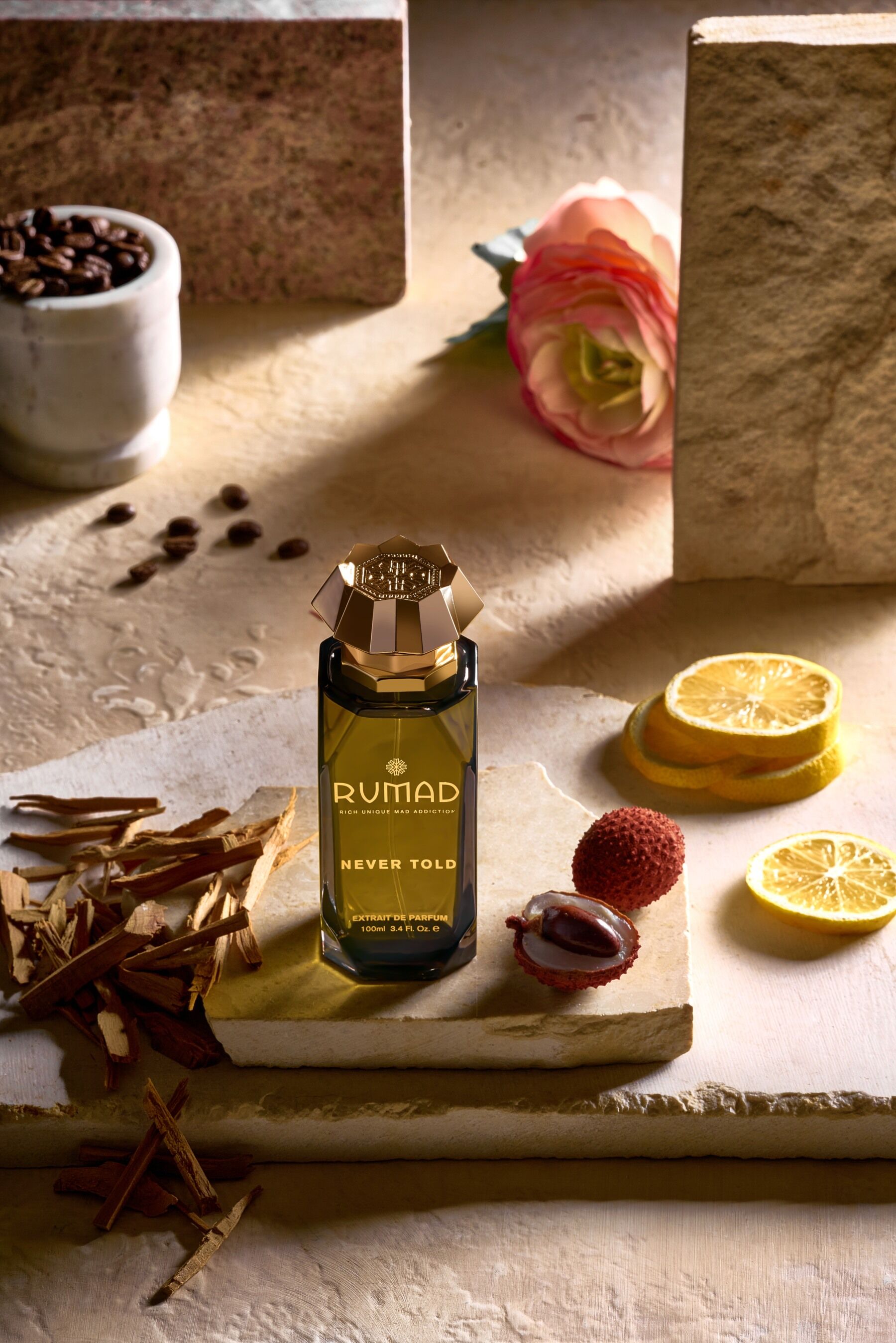 Never Told by Rumad stood against pale stones with lemon slices and other ingredients surrounding it