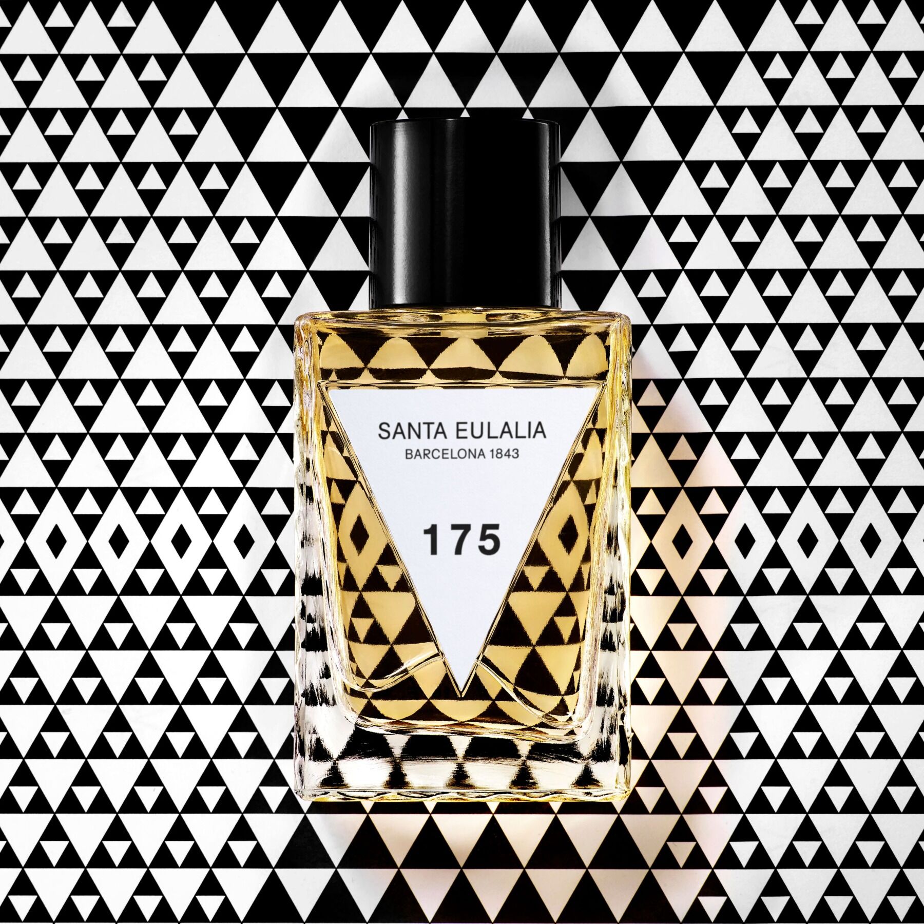 A bottle of 175 laid on a background of triangles