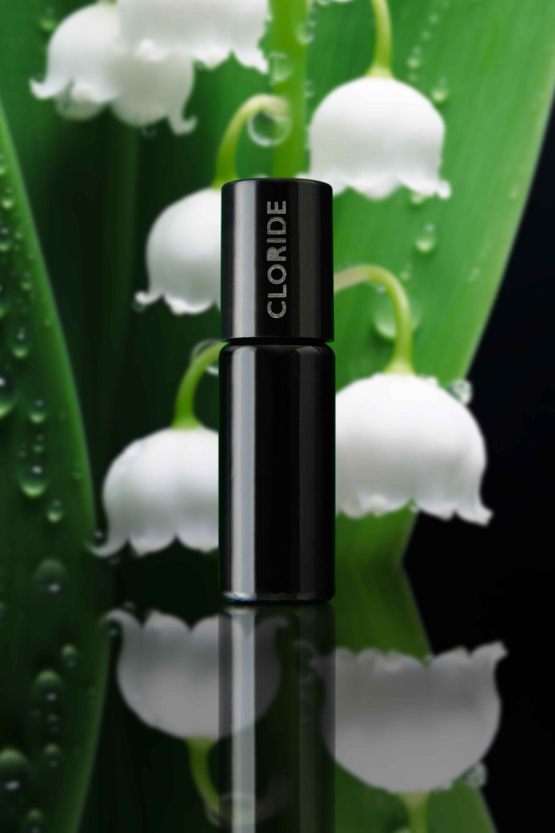 A bottle of Chloride set in front of lily of the valley