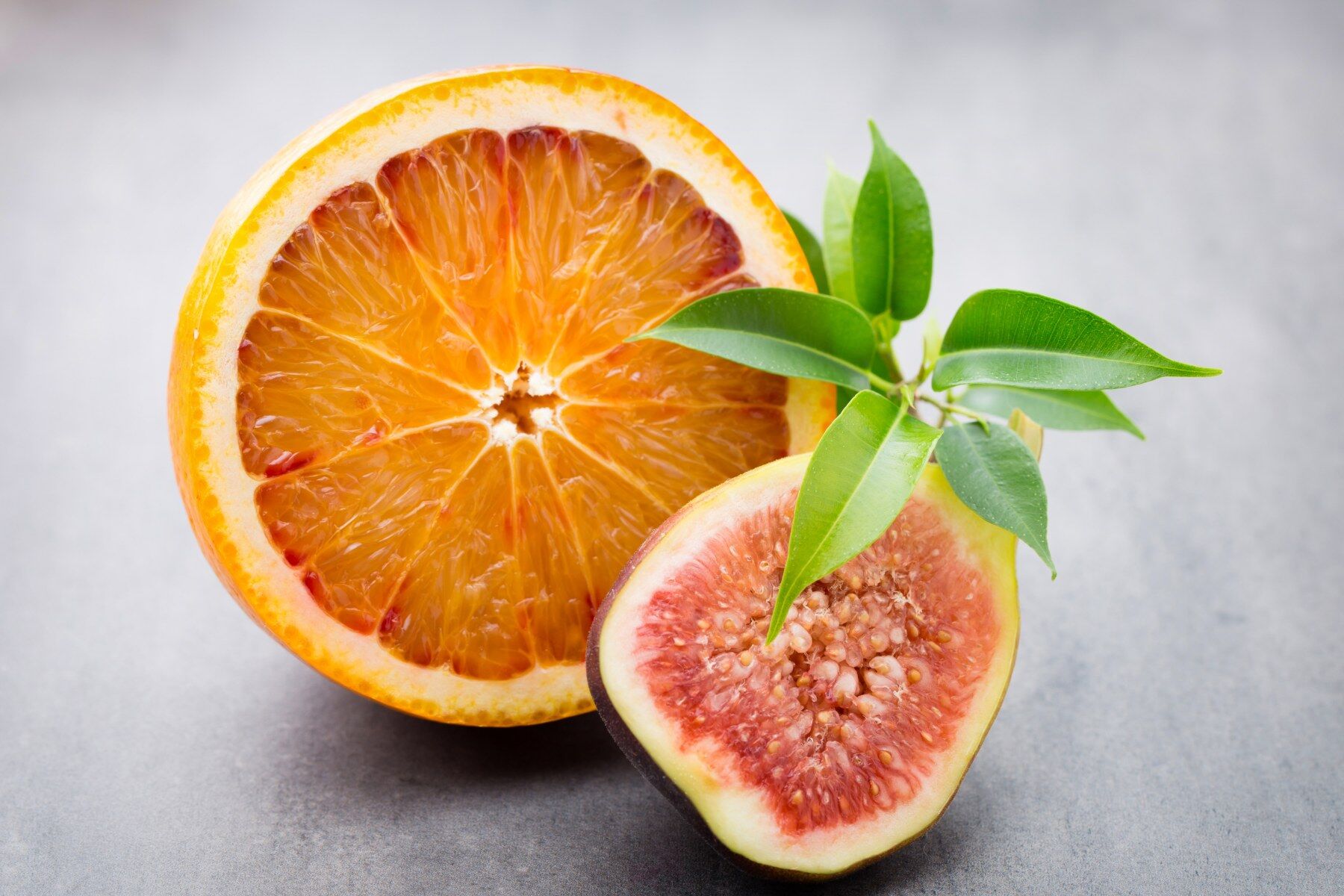 A fig and an orange cut open