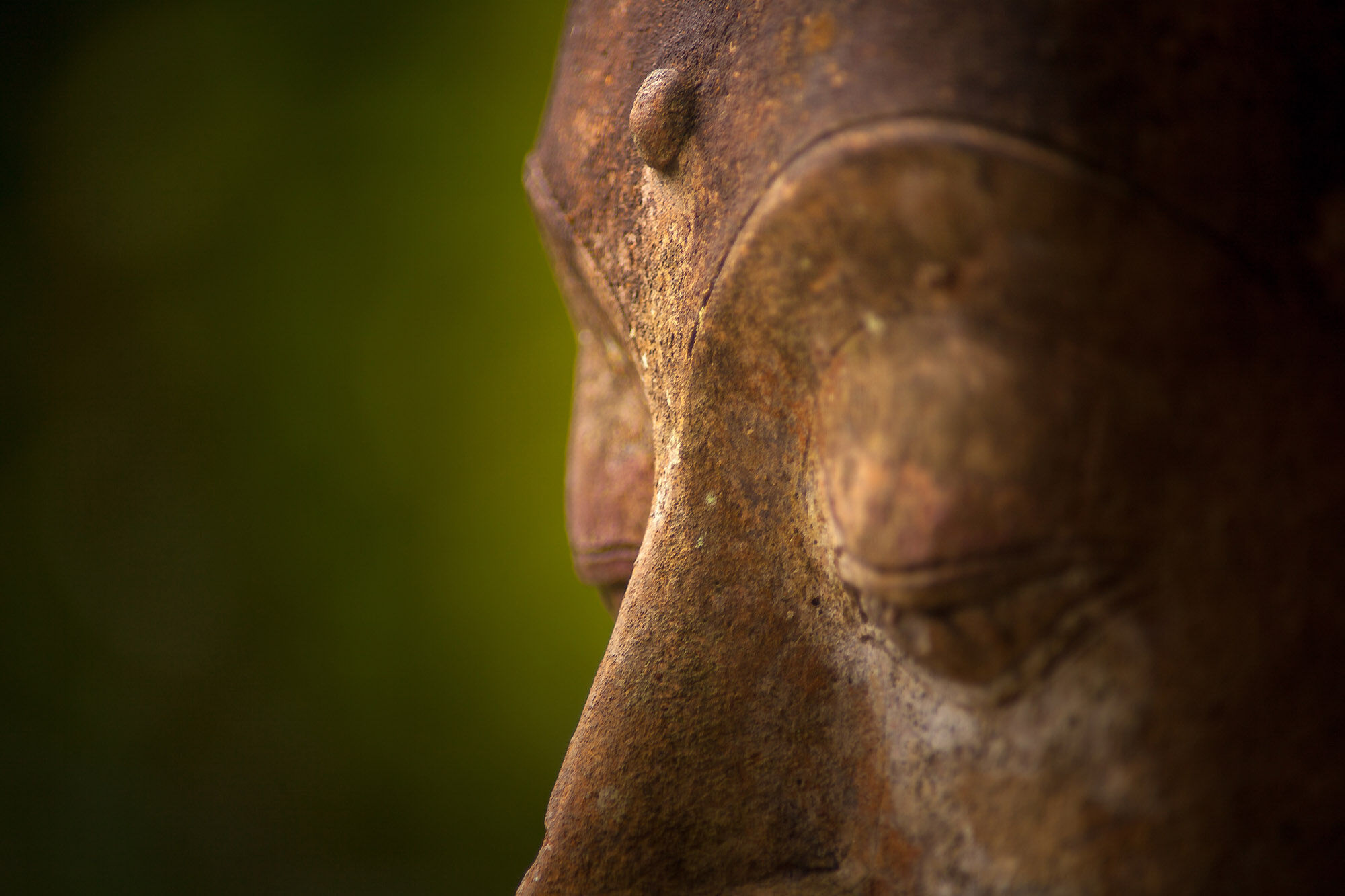 Buddhist statue with visible third eye.