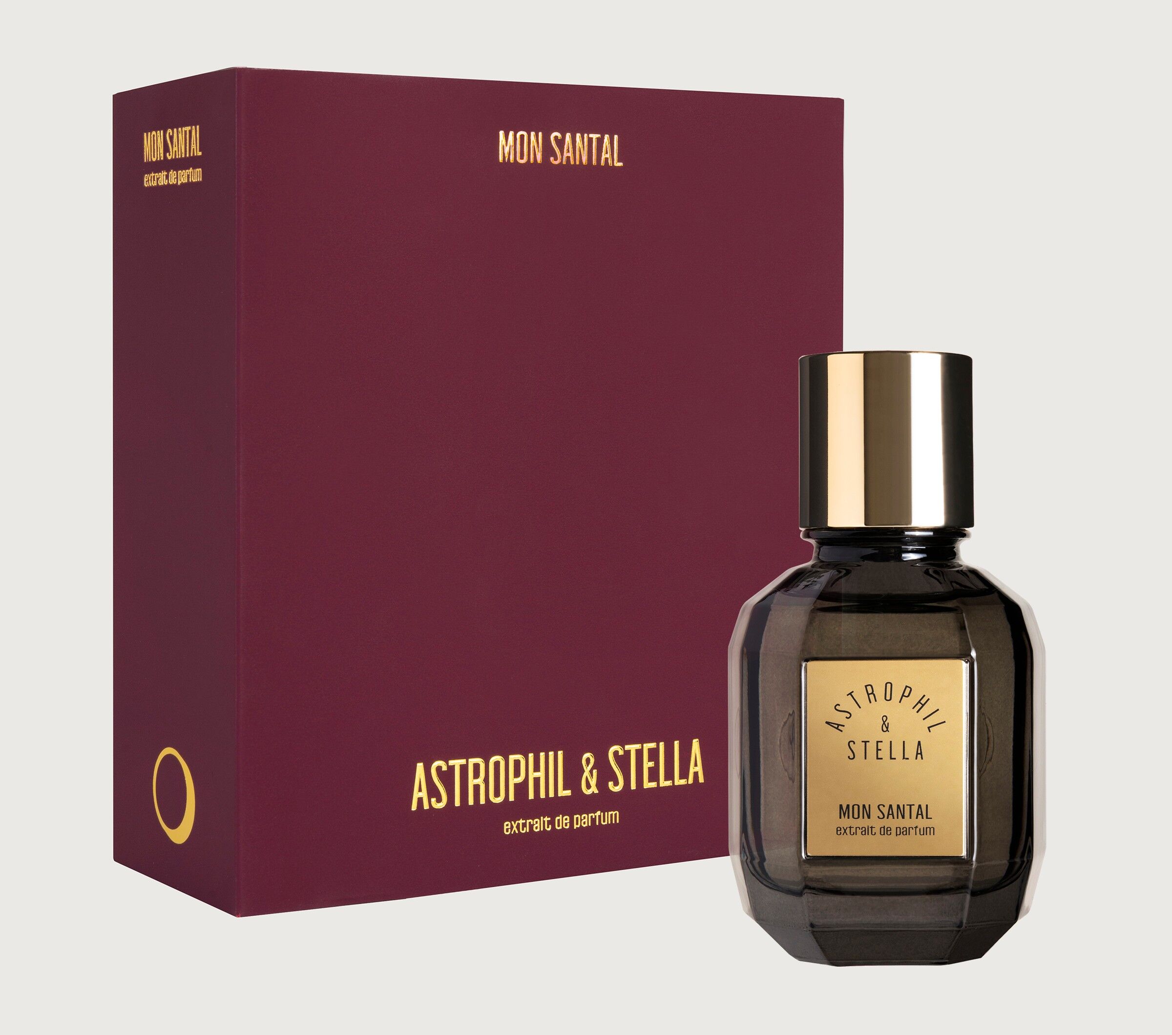 A box of Mon Santal and a bottle next to it on a grey background