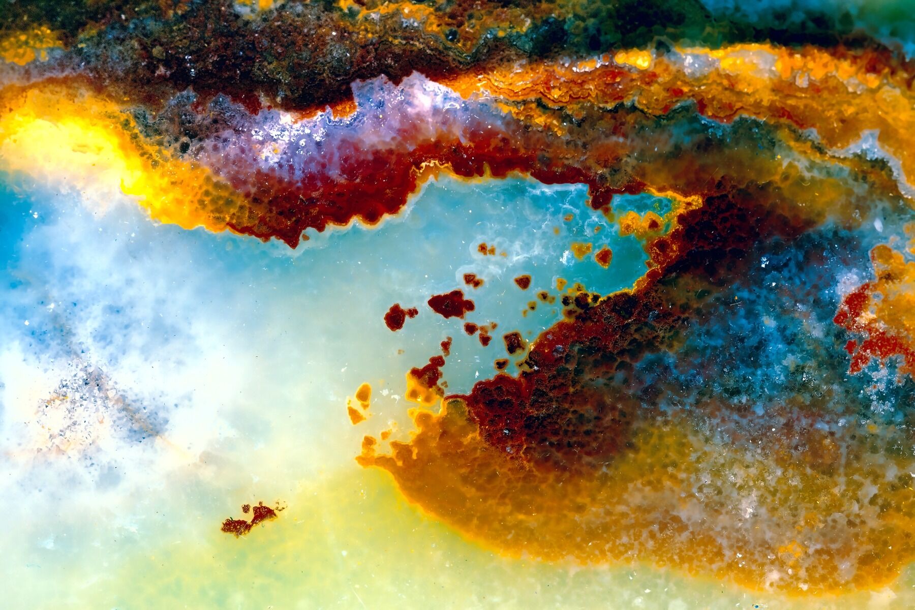 A close up of an opal showing different crystals and textures and colours in the rock