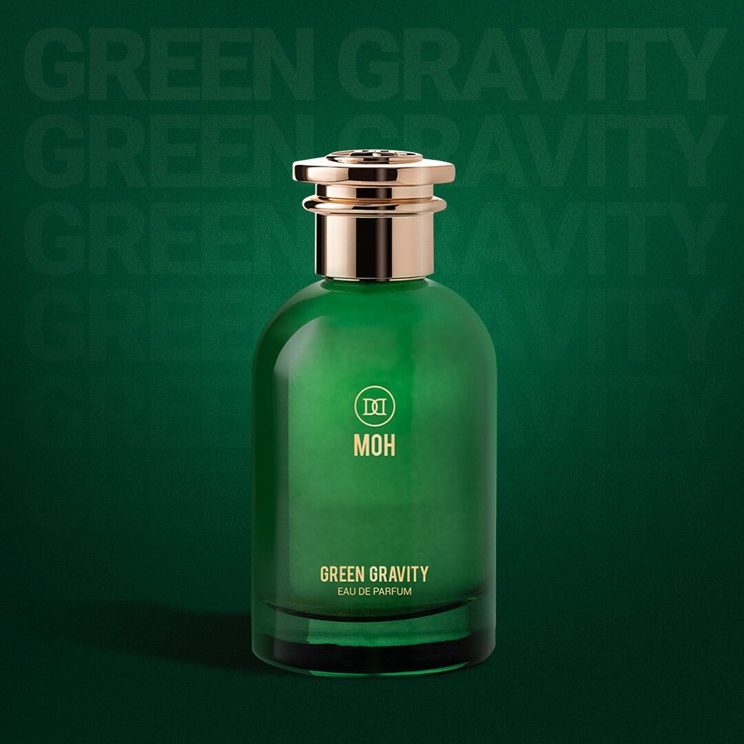 A bottle of Green Gravity on a green background with faint words saying Green Gravity behind