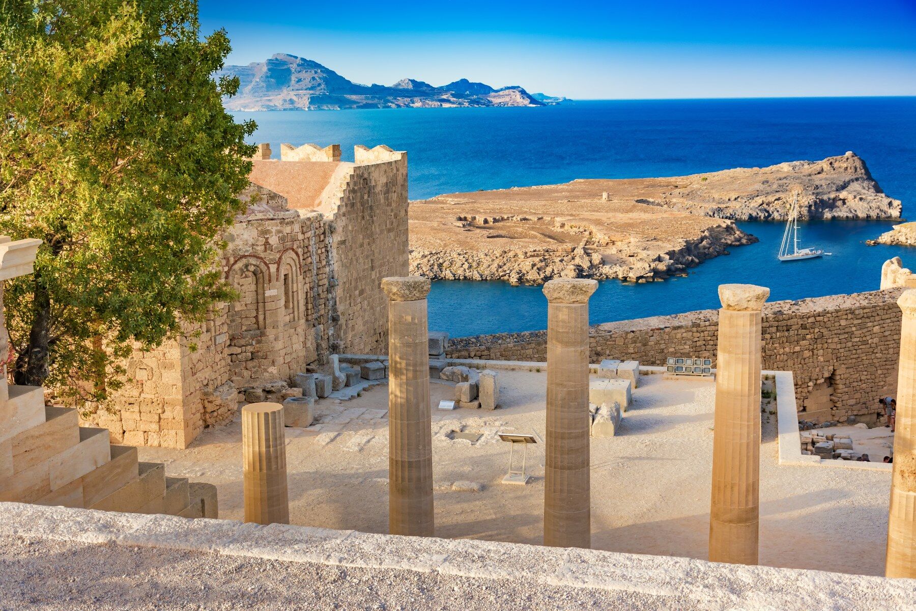 Greek ruins against a bright blue sky