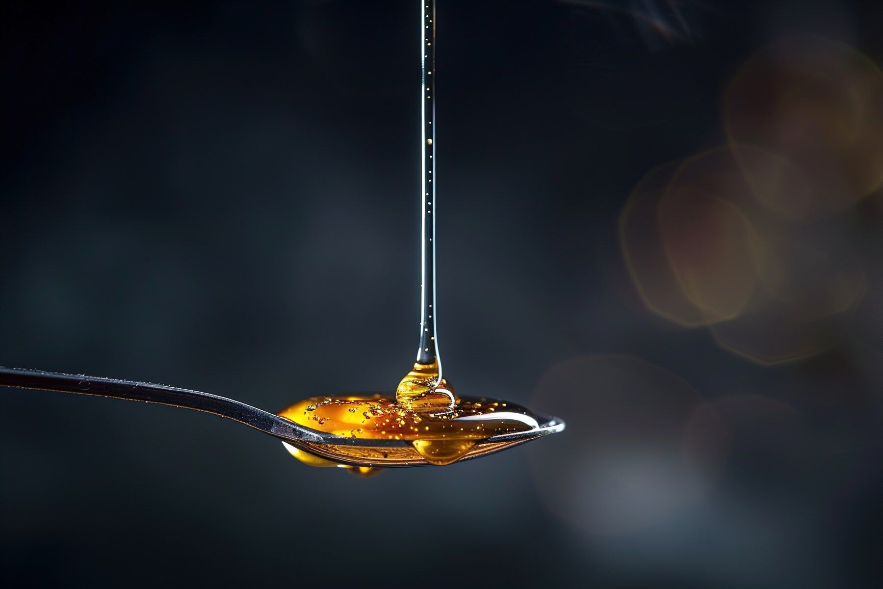 Golden syrup being dropped on to a teaspoon