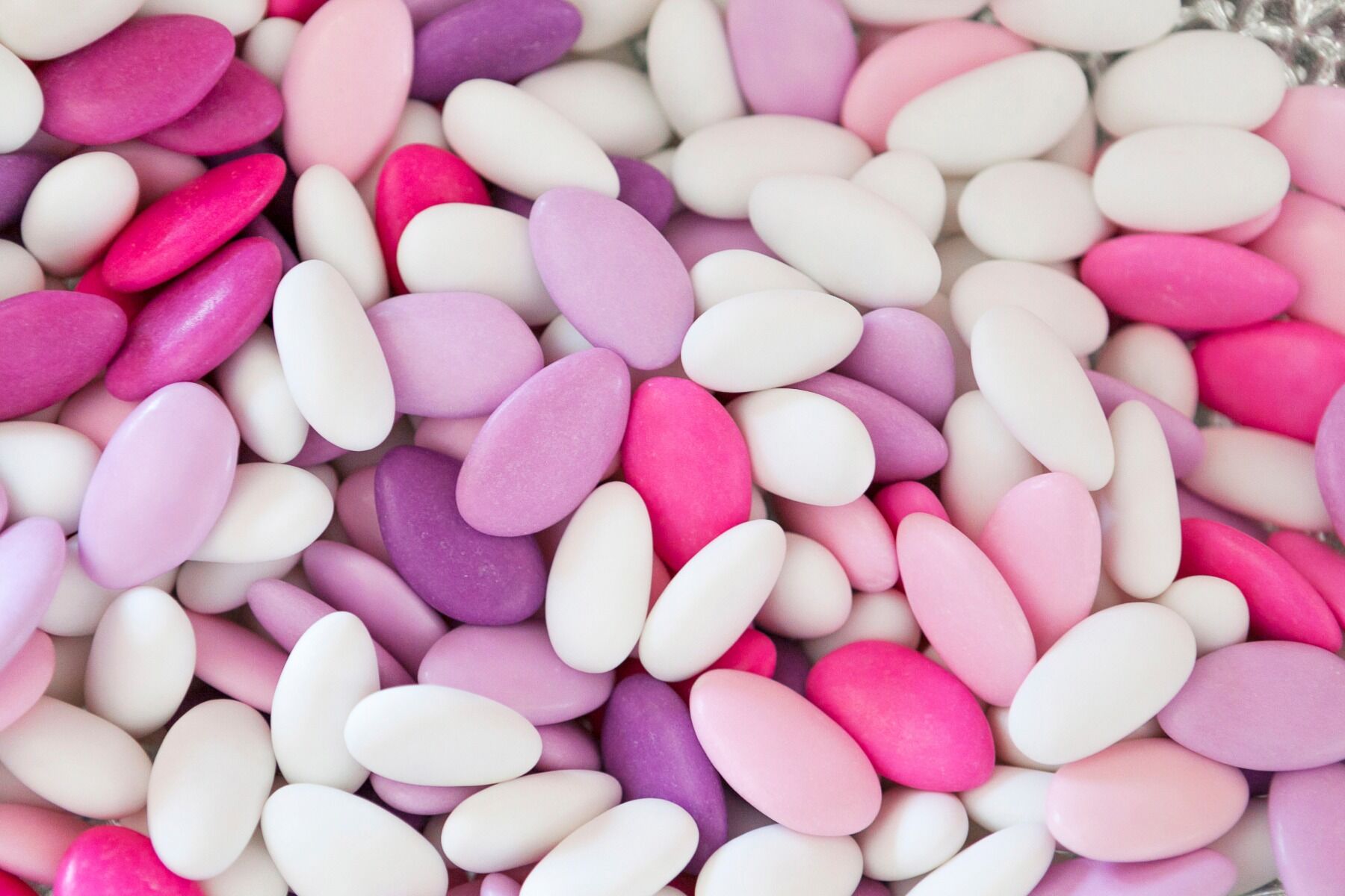 A photo of sugared almonds in pinks, purples and whites