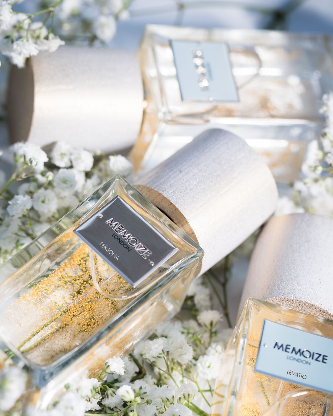A close up of fragrance enhancers with floral blooms in white