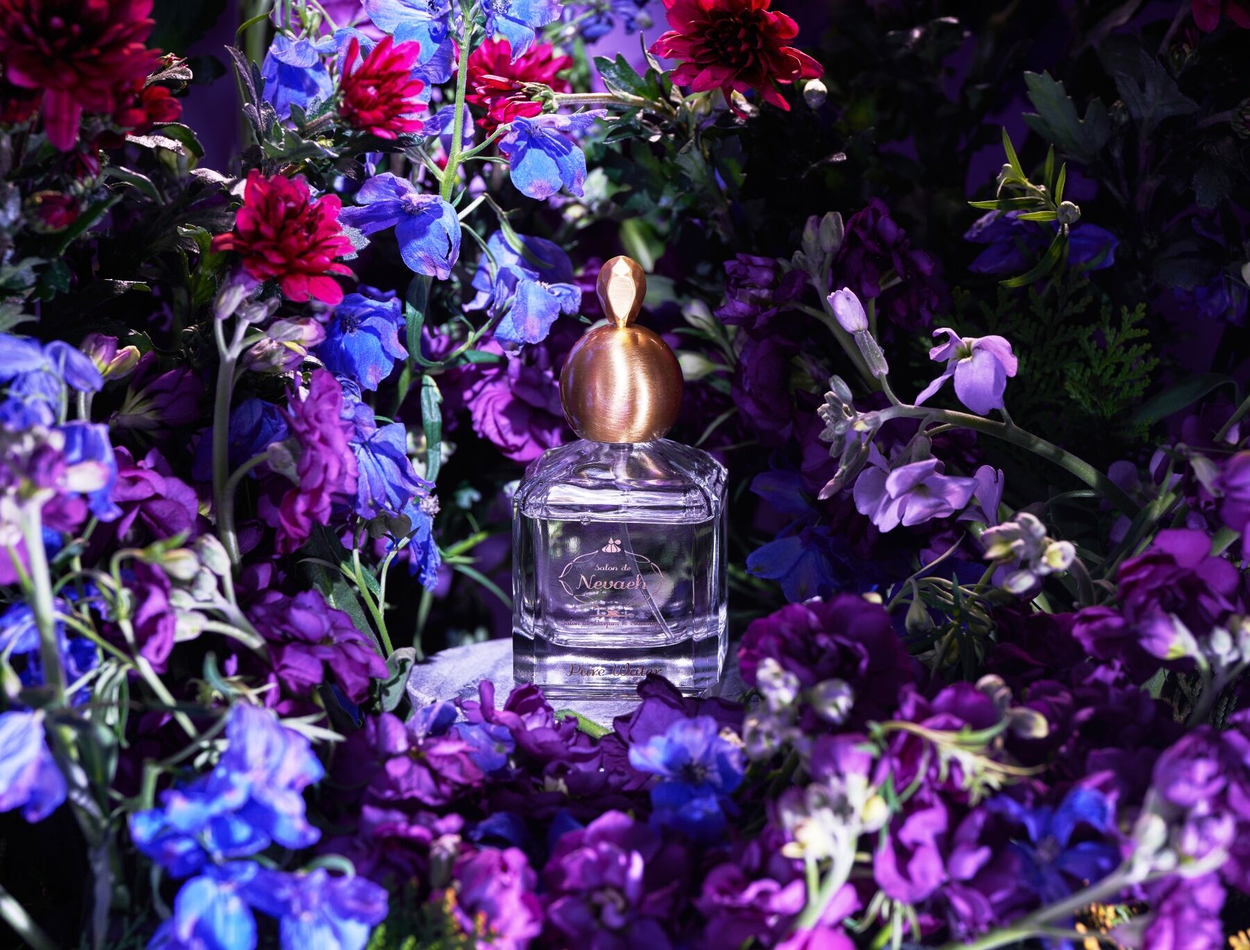 Pure Water by Salon de Nevaeh set against a lush backdrop of flowers