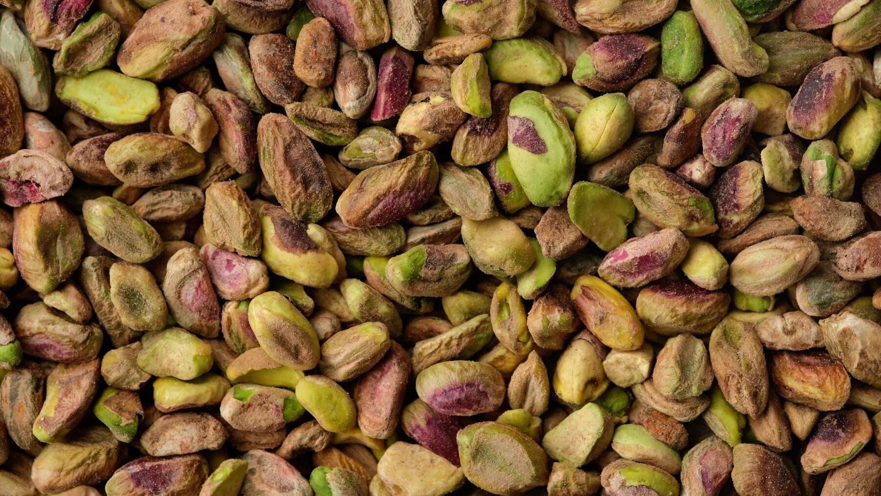 Pistachio nuts showing their brown, green and purple colours