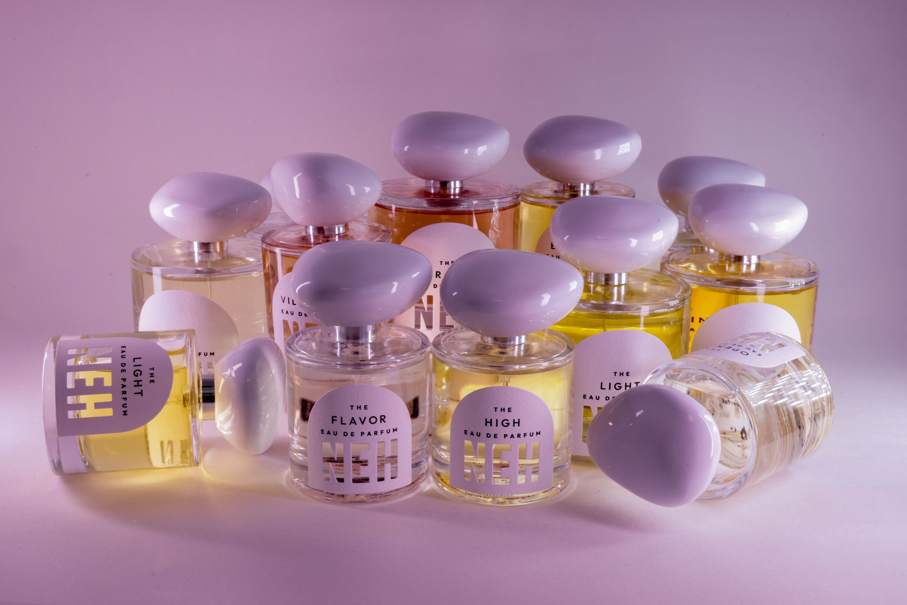 A group shot of the Neh perfumes on a purple backdrop