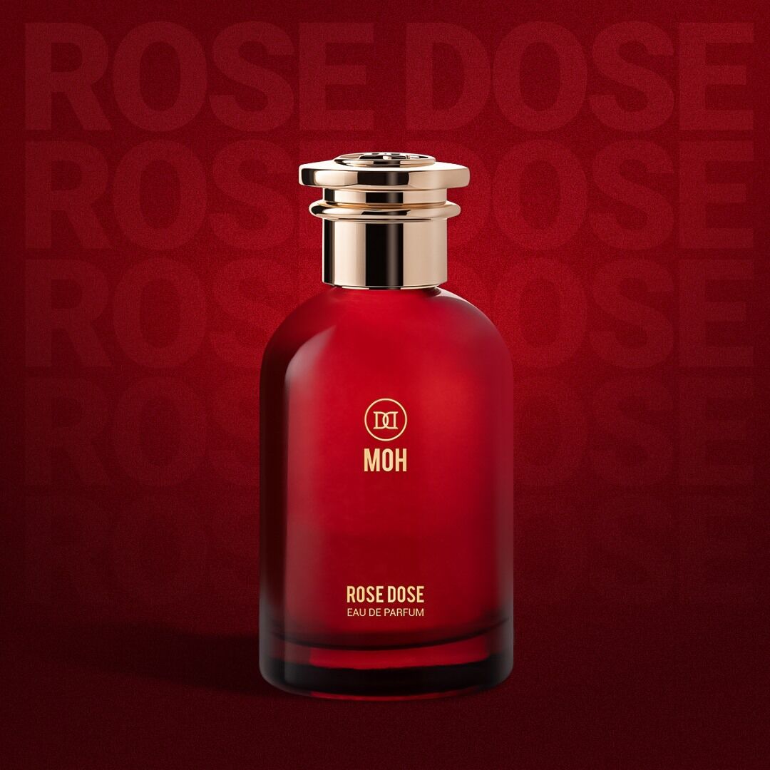 A bottle of Rose Dose on a red backdrop with the name showing faintly behind