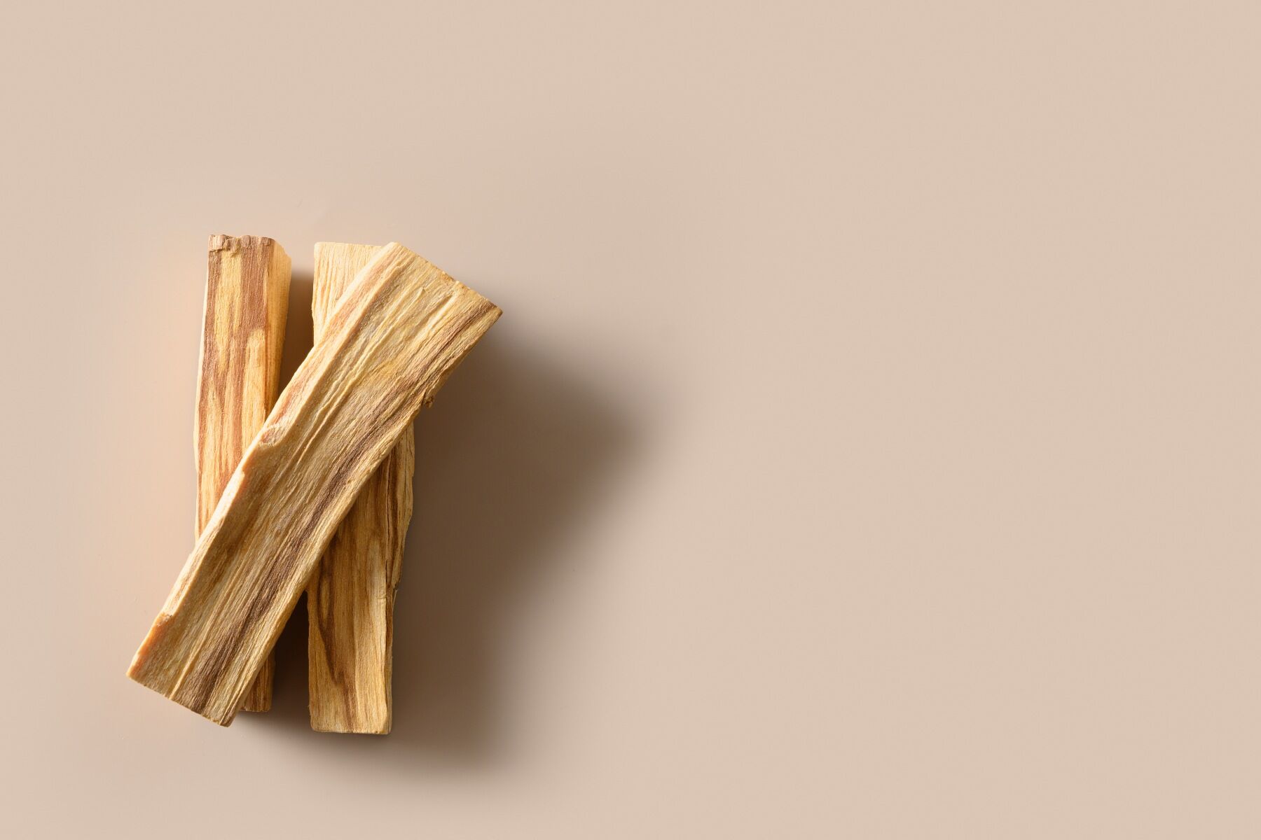 Wooden sticks of sandalwood against a neutral backdrop