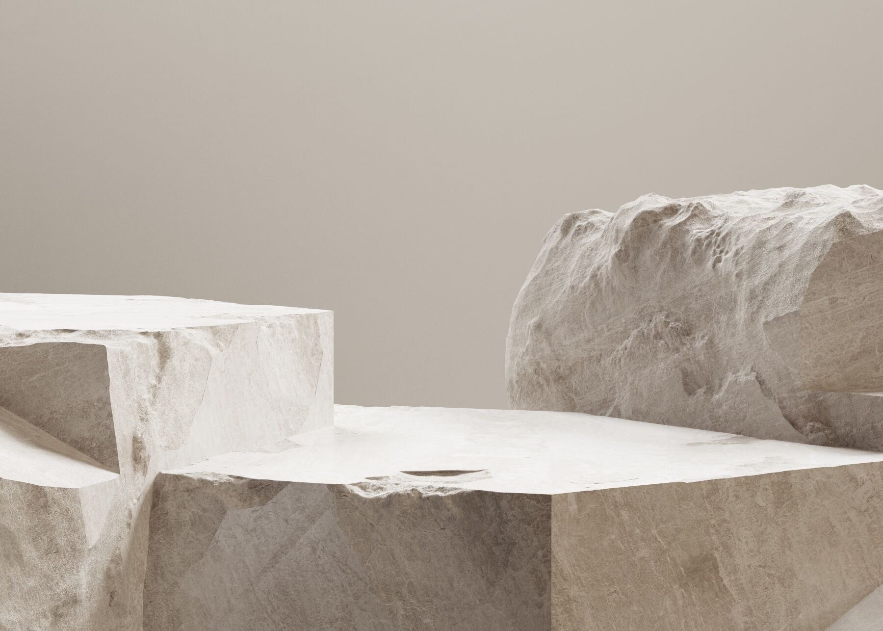 Stone blocks arranged in front of a beige backdrop