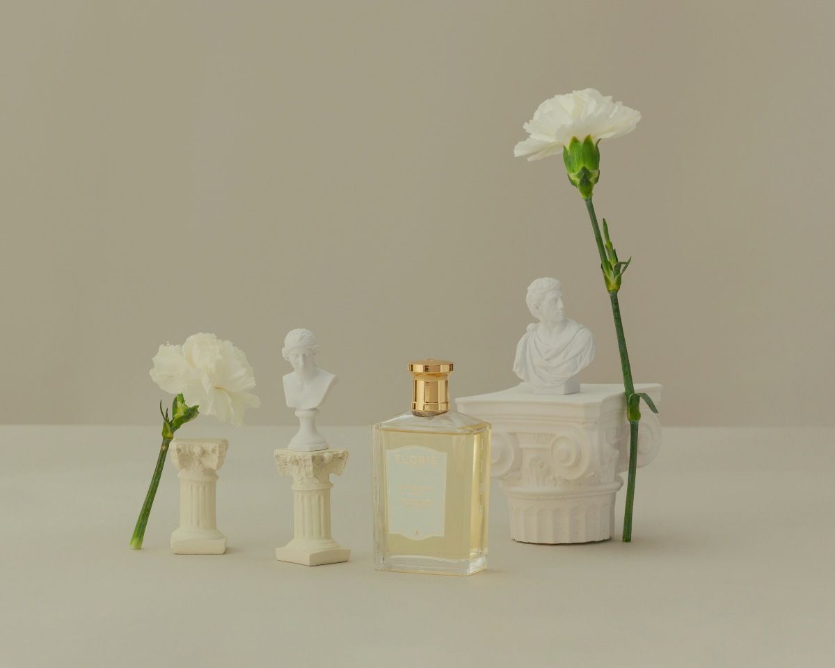 Stephanotis perfume from Floris shown on a beige background with white flowers alongside