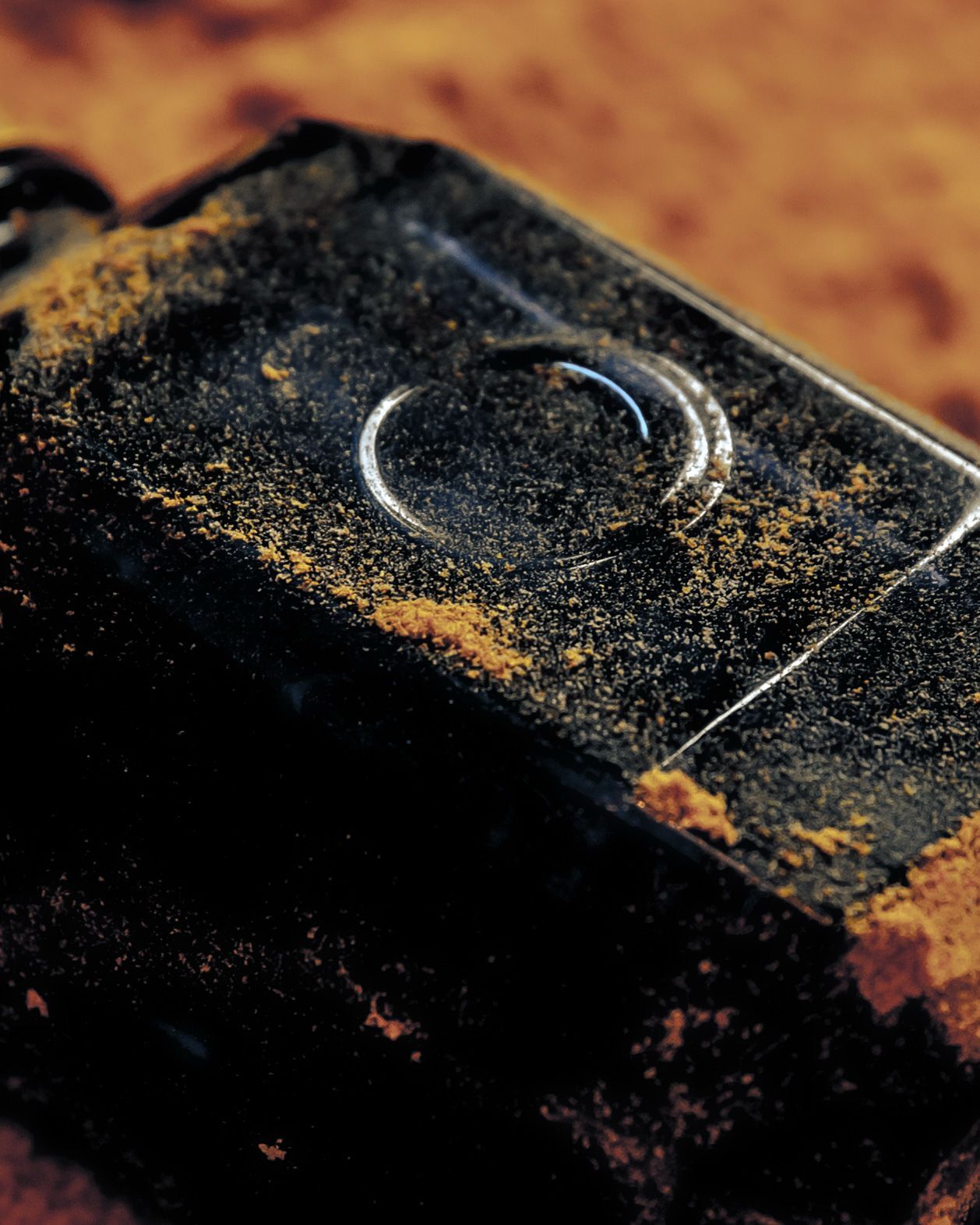 A bottle of Nabati Oud covered in the dust of the desert